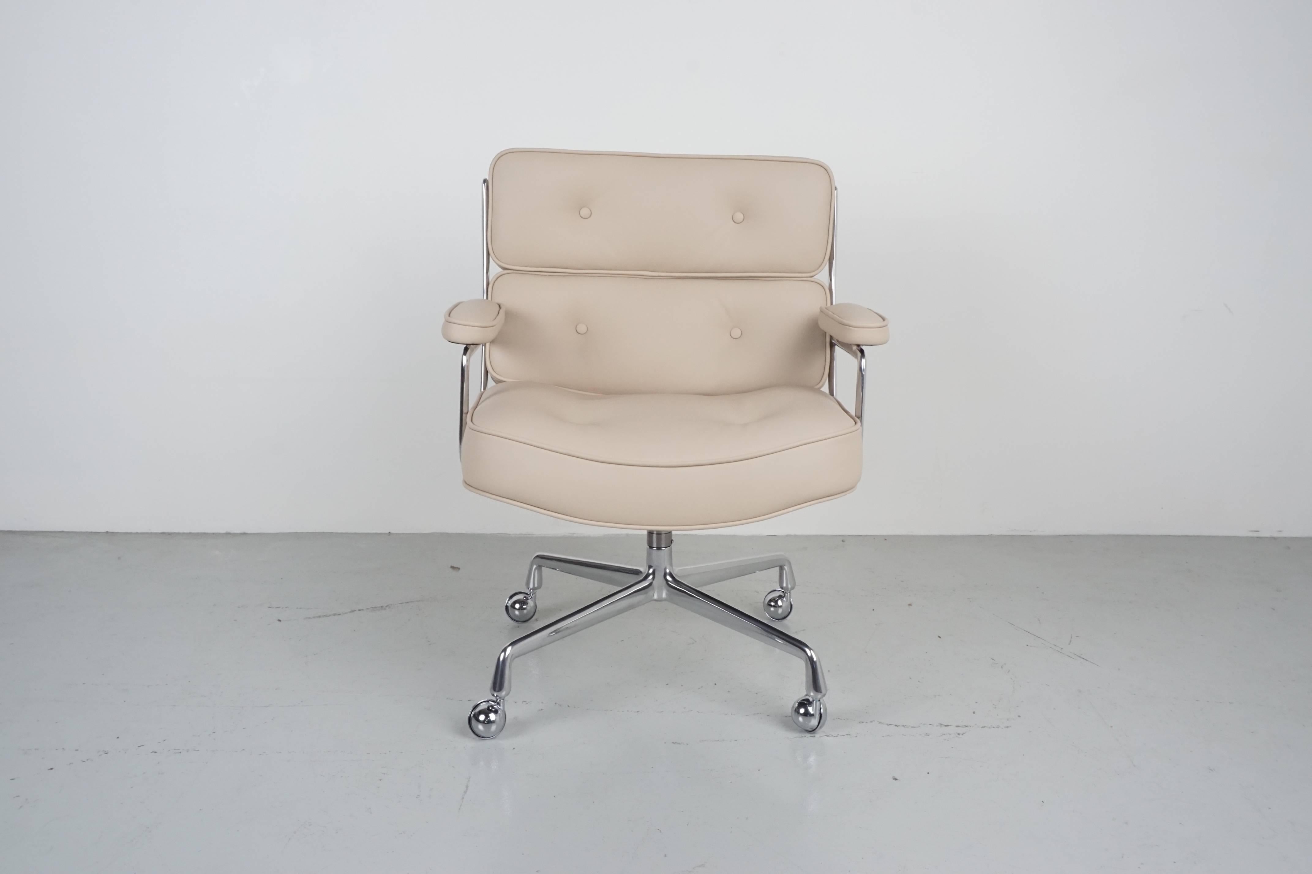 Eames time life chair reupholstered in cream colored leather. Newly polished aluminum base and casters. Chair tilts, swivels and goes up and down.