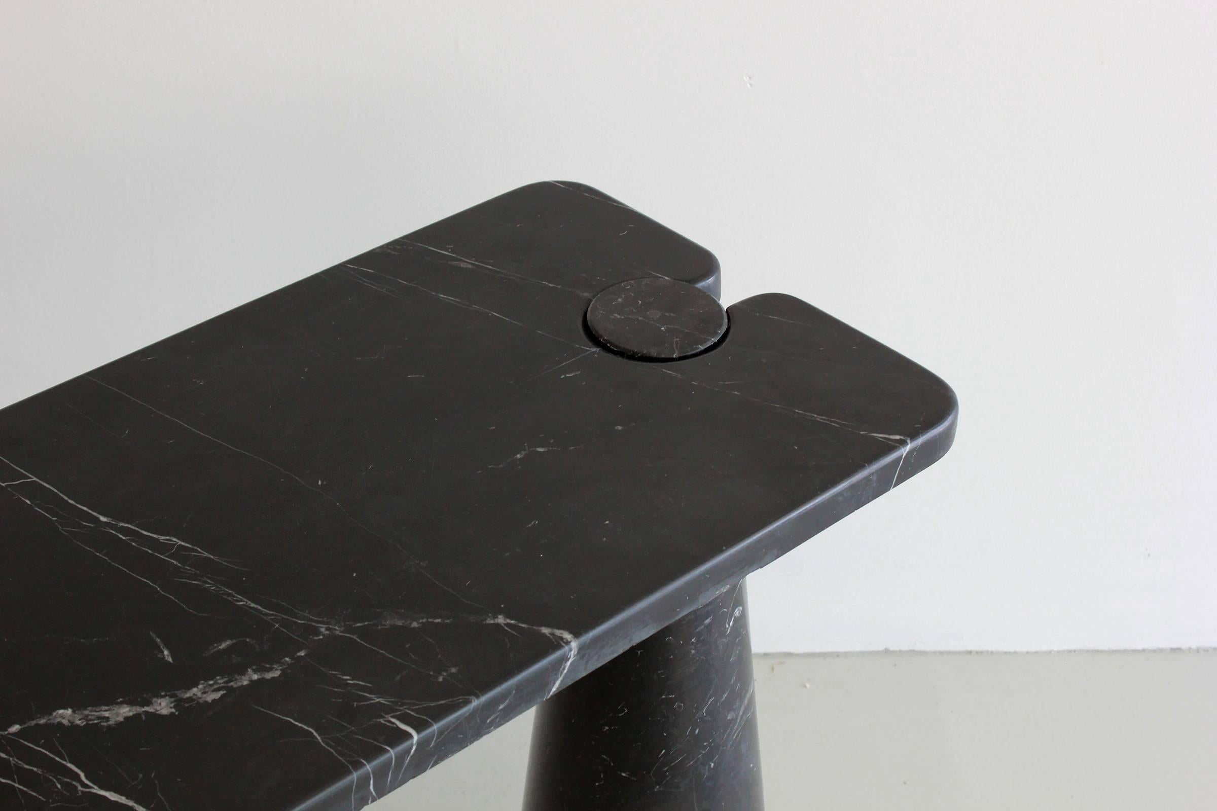 Gorgeous marble console from Mangiarotti’s Eros series. Beautiful black marble top held by two black marble conic pedestals with light white veining throughout.