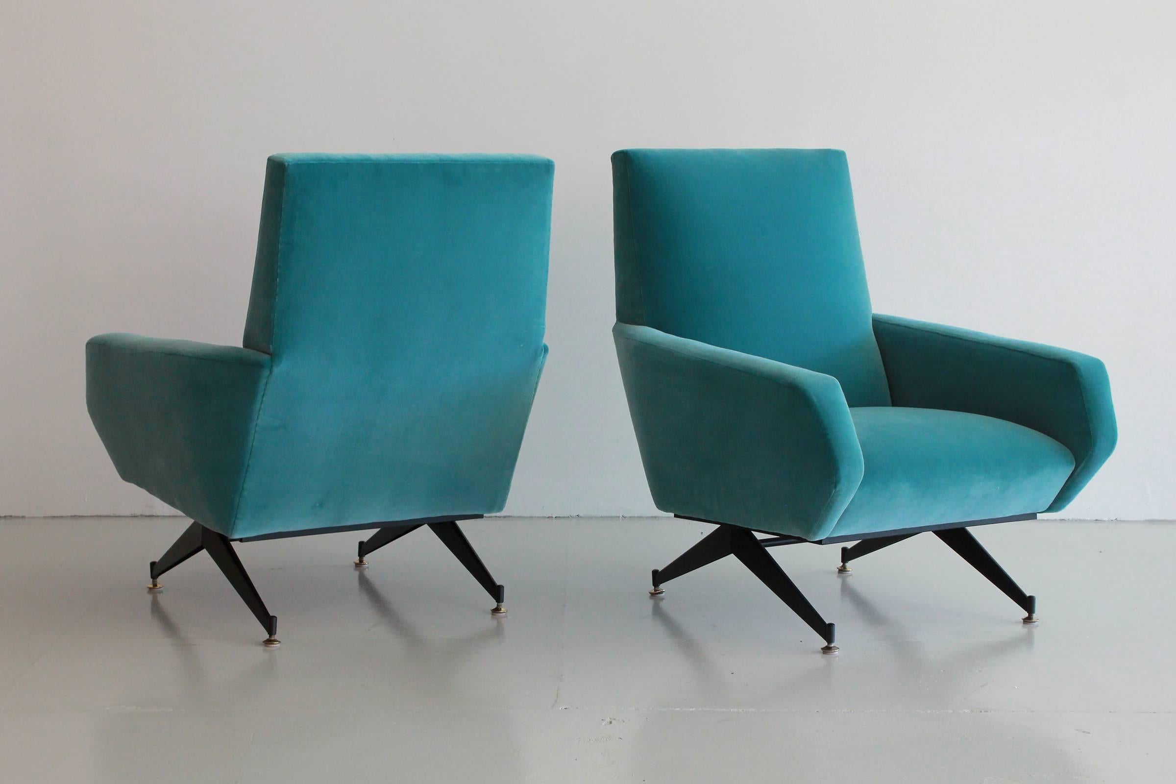 Gorgeous pair of Italian club chairs with great lines in the style of Minotti. Black iron base and brass feet. Reupholstered in gorgeous teal blue velvet. Sold as a pair.