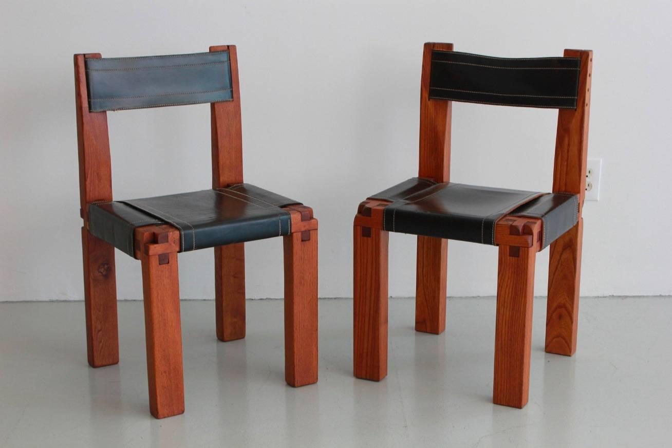 Pair of chairs designed by French designer Pierre Chapo for Atelier Chapo, Paris. Cubic design of solid elmwood with black leather seat. Beautiful wood joint detail and fantastic patina to leather with contrast stitching. Priced as a pair.