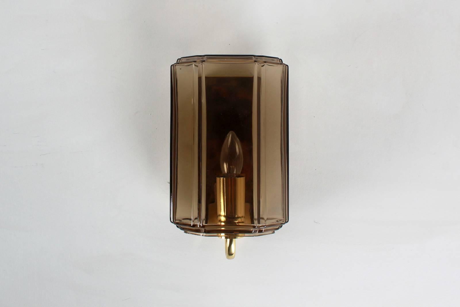 Beautiful Austrian sconces with topaz colored smoked brown glass in a cylindrical geometric shape. Brass hardware and newly rewired. Three available and sold individually.