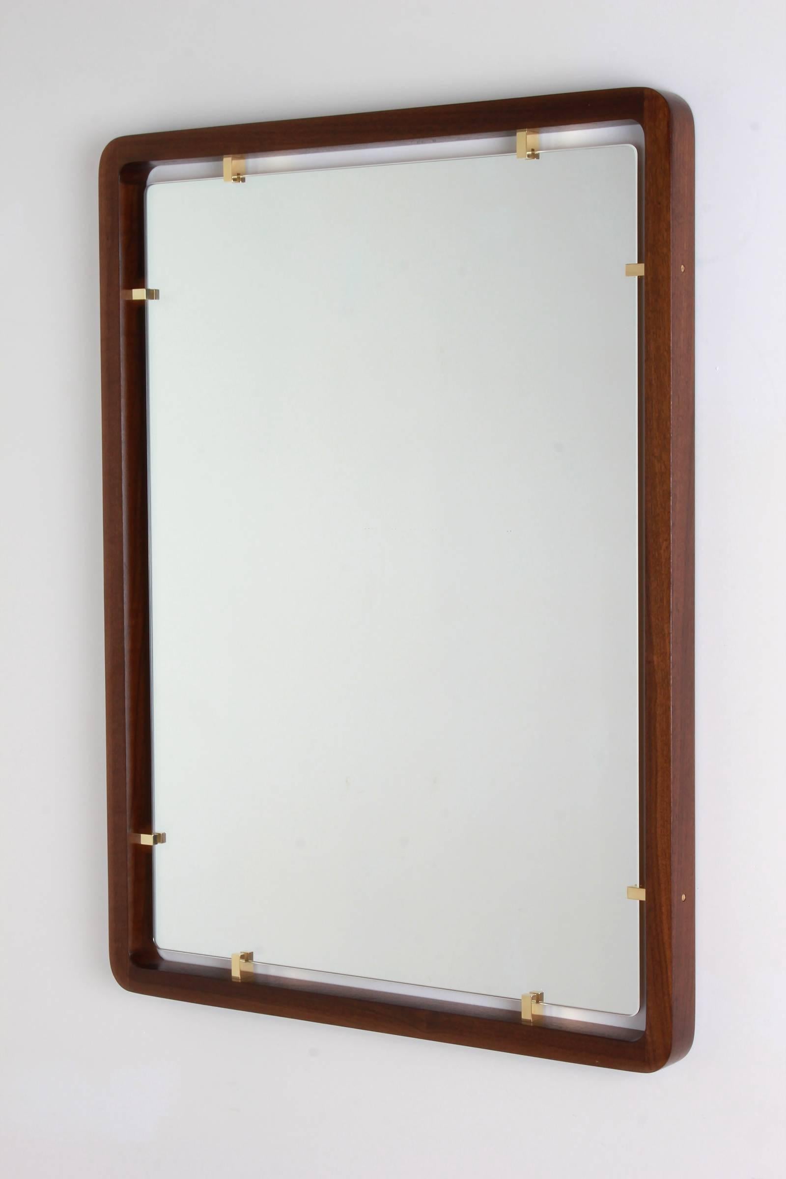 Floating mirror with walnut frame and solid brass fittings. 
Custom sizes available.