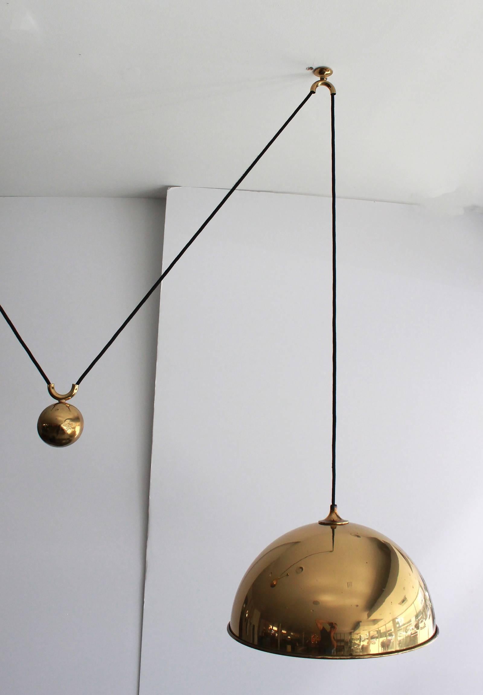 Large brass counter balance light by Florian Schulz. Impressive dome pendant cloth cord with heavy ball counterbalance. Light is height adjustable. Excellent vintage condition.
