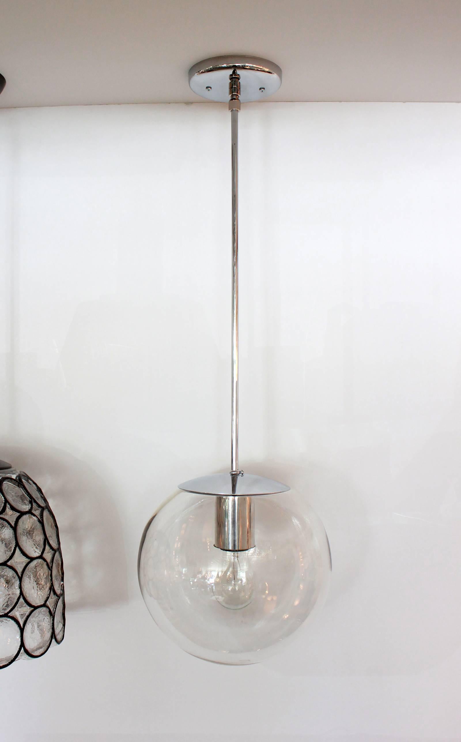 Clear hand blown glass globe with nickel hardware and canopy. Newly rewired. Two available. Priced individually.