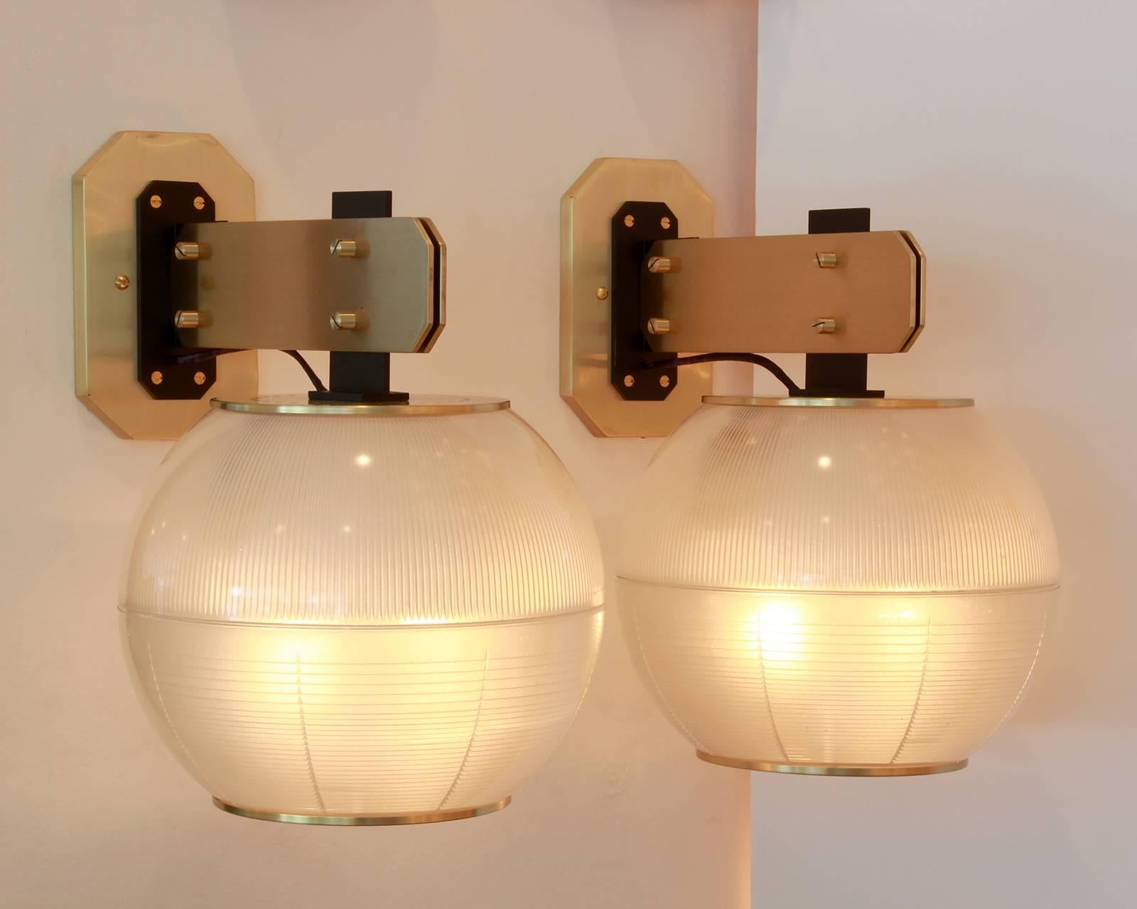 Pair of globe sconces with ribbed and textured glass. In the style of Gardella, possibly made by Stilnovo, circa 1964. Large in scale with beautiful brass hardware. Newly rewired.