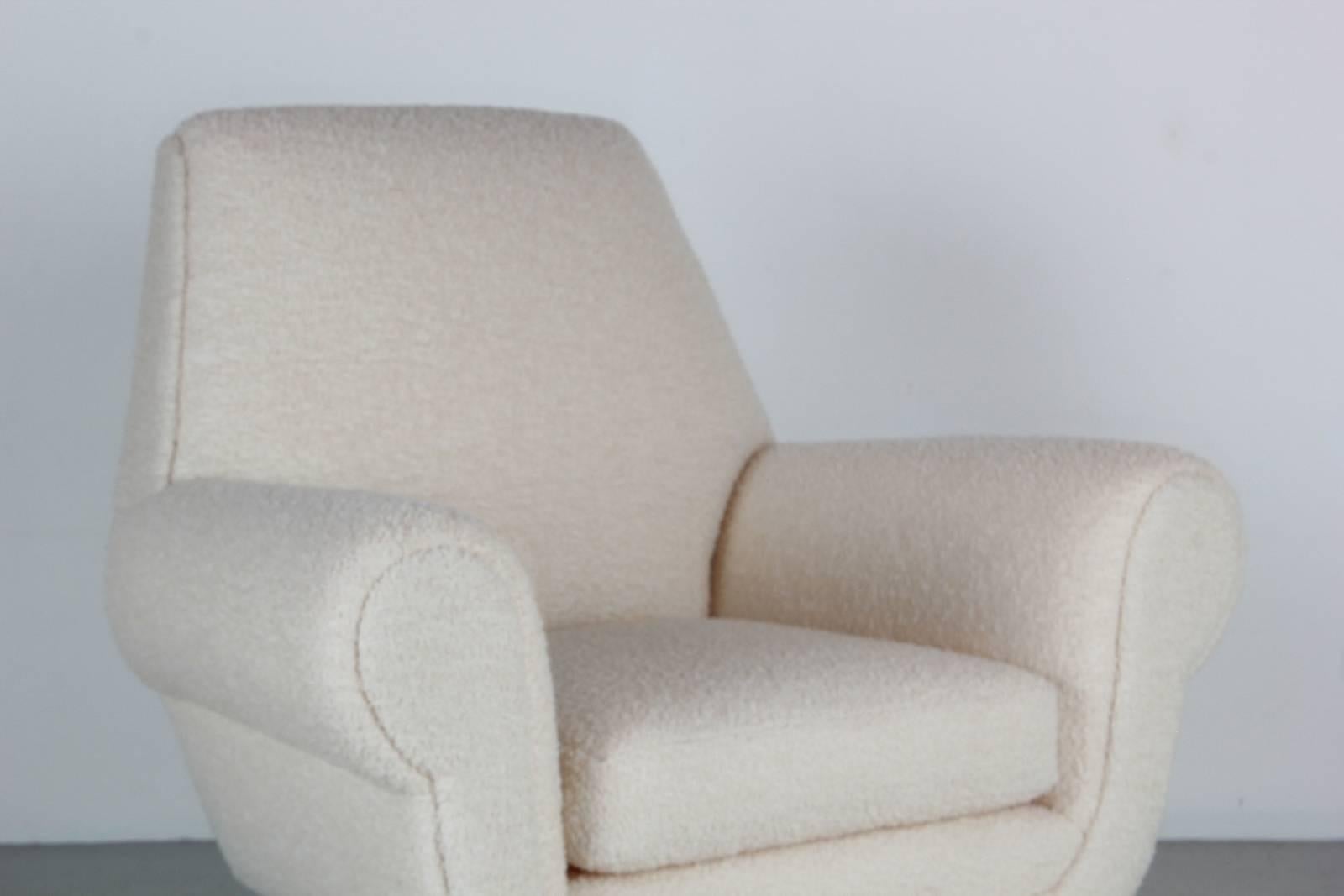 Fantastic Italian club chairs designed by Gigi Radici upholstered in a creamy white bouclé with polished brass legs.