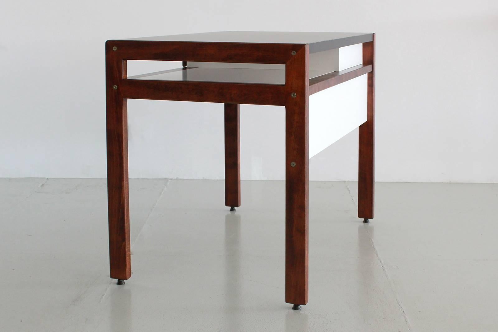 Writing desk by Andre Sornay with black laminate top, white back and wood drawer and legs.
         