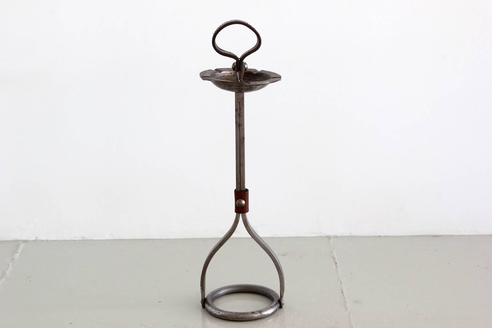 Wonderful iron Adnet ashtray stand with brown leather loop handle and leather strap detailing. Circular iron base and ashtray holder. Great patina to original iron and leather.