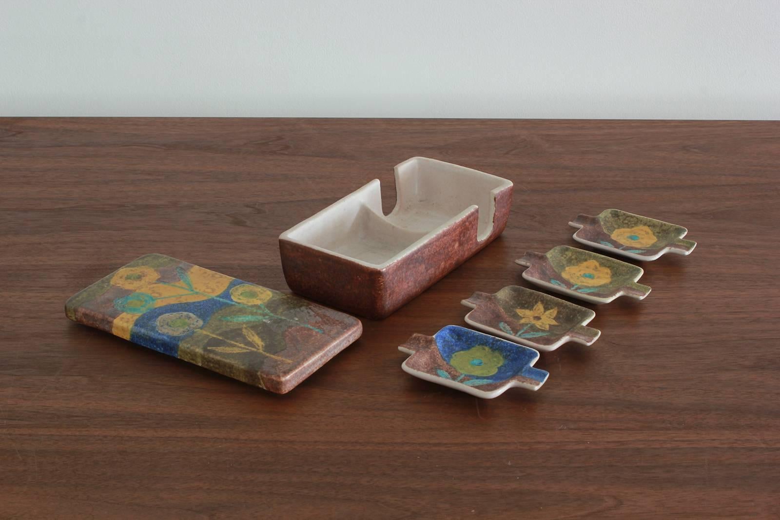Signed Raymor Italian smoking set with four ashtrays and cigarette box. Vintage mid-century signed Raymor Italy pottery, floral motif, smoker set with ashtrays and cigarette box.



Approximately: 8