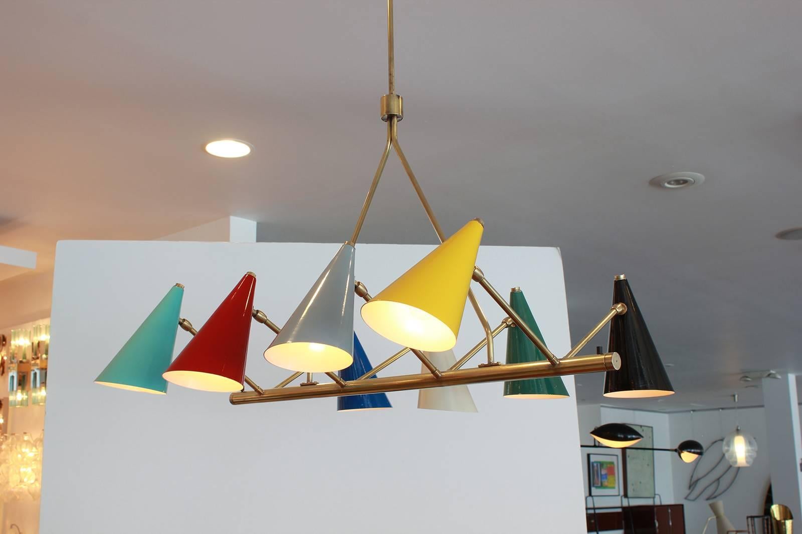 Fantastic articulating Italian chandelier with nine different colored cone shades in original colors. Brass arms and hardware.
Would be great above kitchen island or pool table! 

Measures: Overall drop: 42" 
Base to joint in drop: 20".