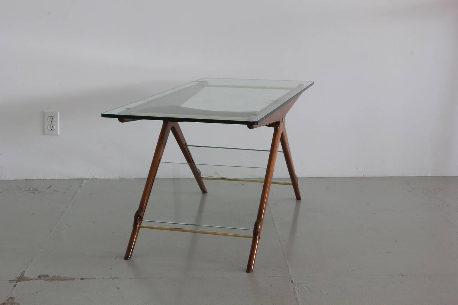 Sleek Italian side table with mahogany, brass accents and original glass.
Glass shelf holds magazines / books!
 