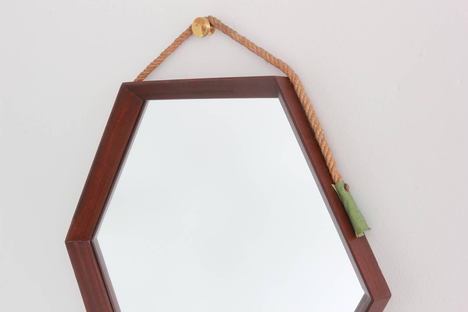 Vintage hexagonal mirror with rope strap and green leather tassle attachment

Bottom of mirror to top of knob measures 20