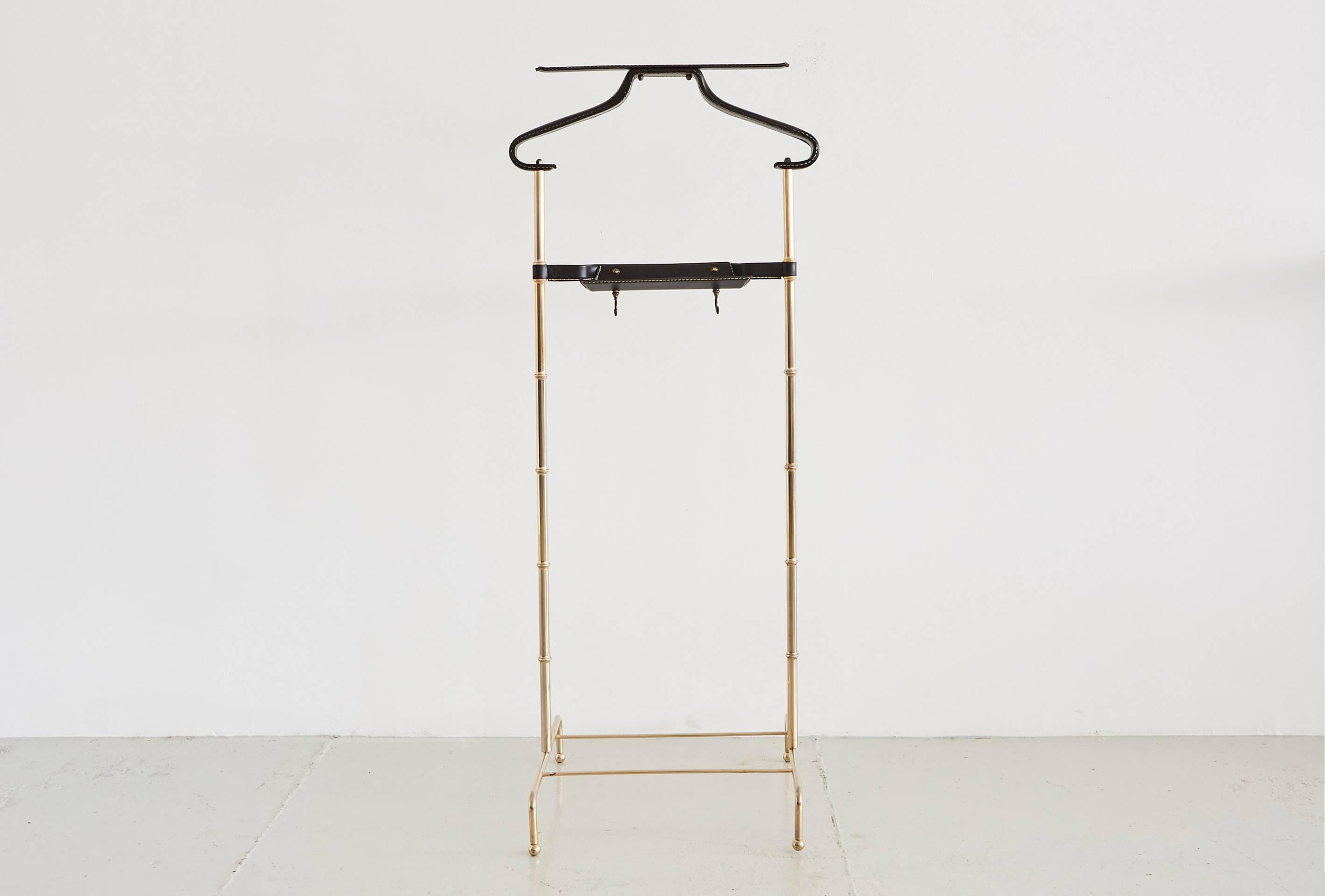 Handsome Jacques Adnet valet with signature black leather coat rack and catch all with brass bamboo base.