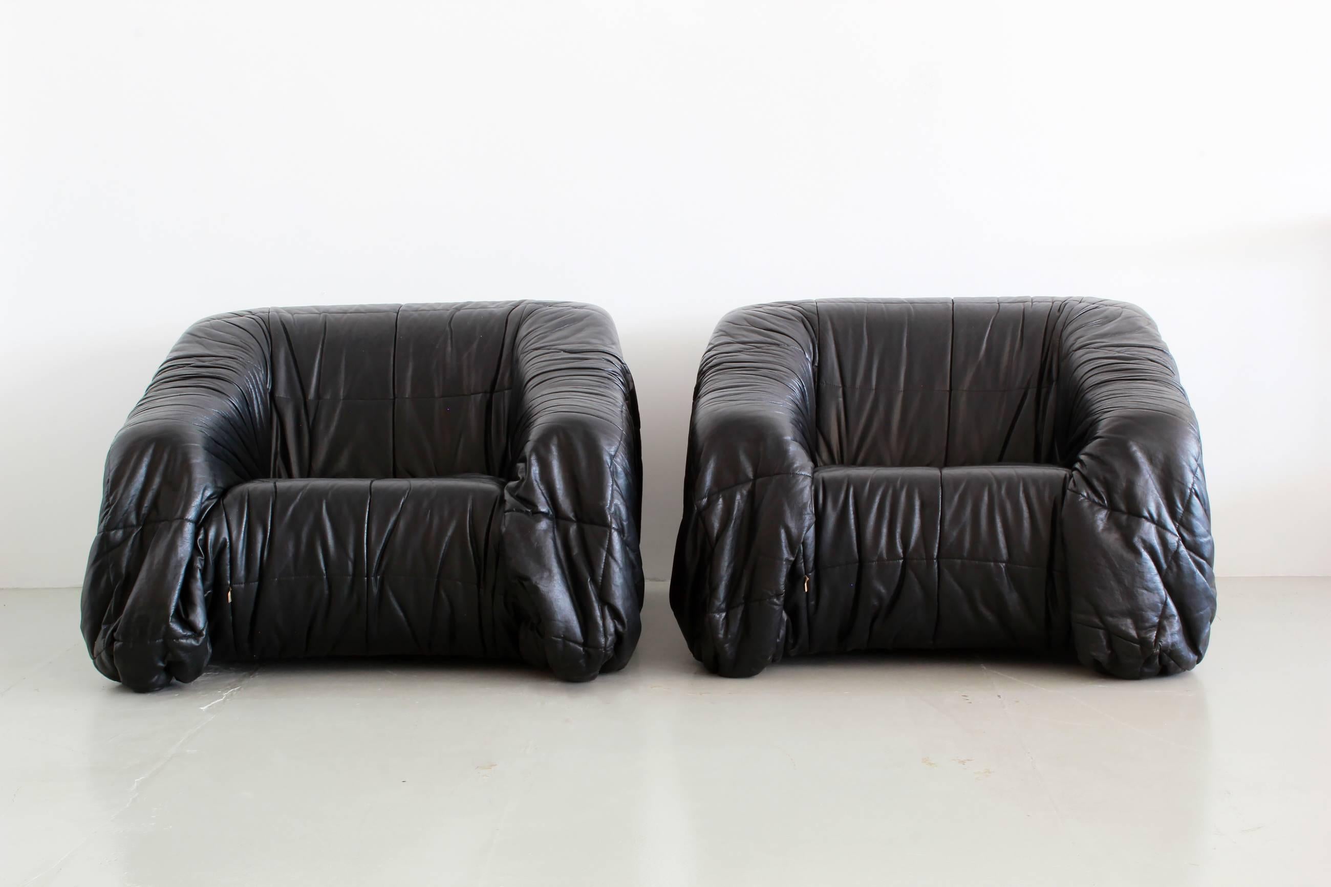 Black leather lounge chairs by Jonathan de Pas, Donato D'urbino & Paolo Lomazzi for Dell'Oca, Italy, 1970. 

Chairs are molded out of foam and covered with folded black, thick butter-soft leather. Extremely large in scale and comfortable!
  