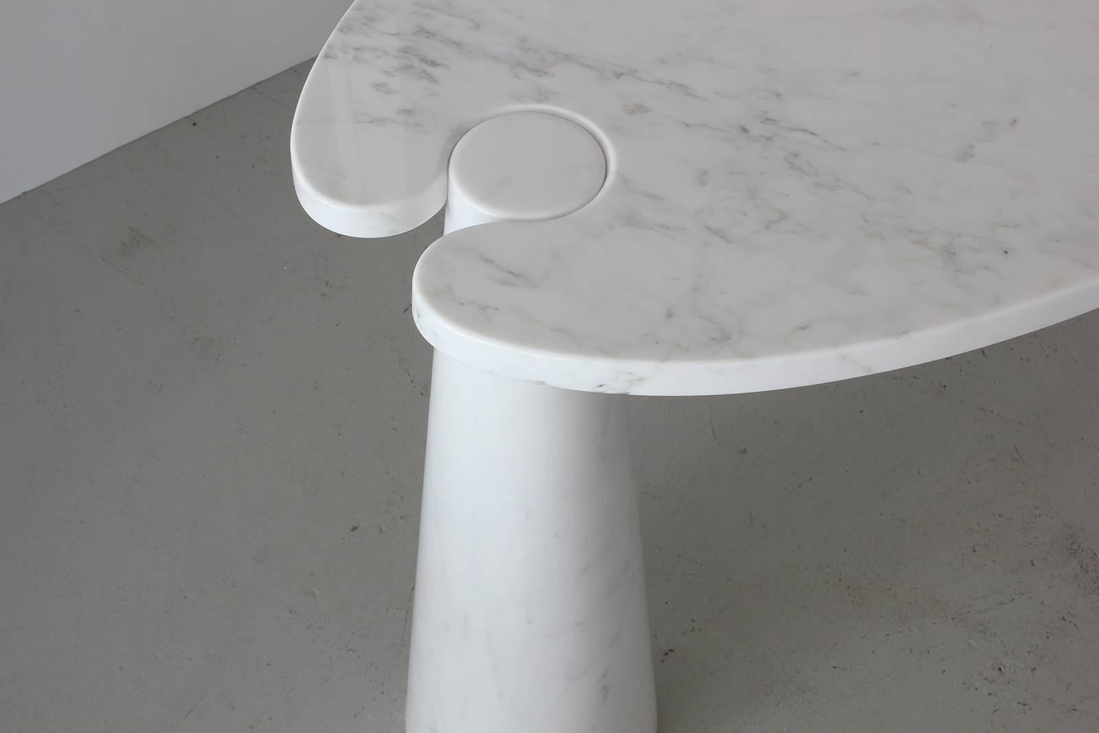Gorgeous marble console from Mangiarotti’s Eros series. Beautiful white Carrara marble top held by two white marble conic pedestals with light grey veining throughout.