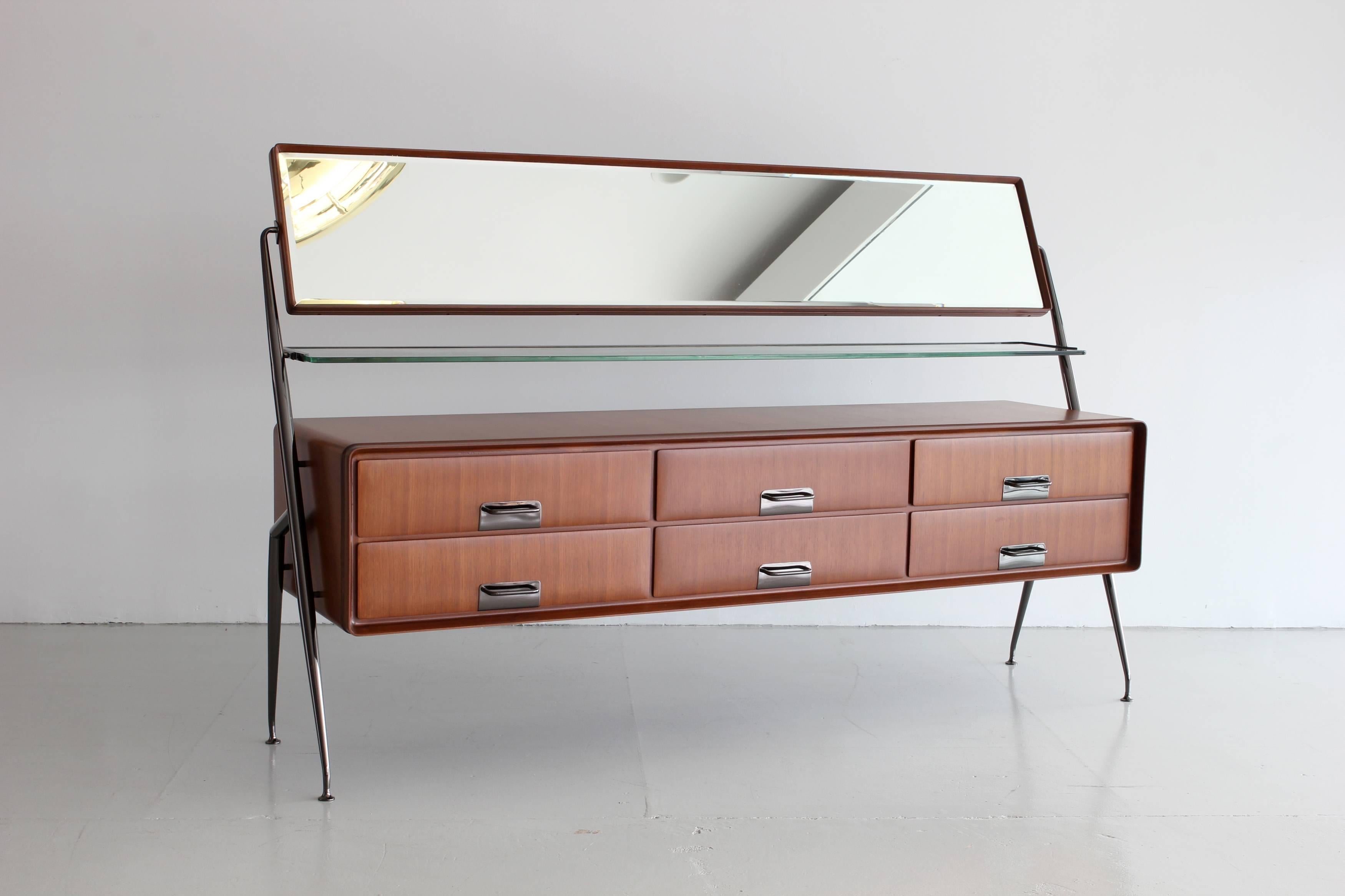 Silvio Cavatorta cabinet with six dresser drawers, horizontal tilting mirror over a glass shelf and tapered angular legs and hardware newly plated in black polished nickel.
Newly refinished.