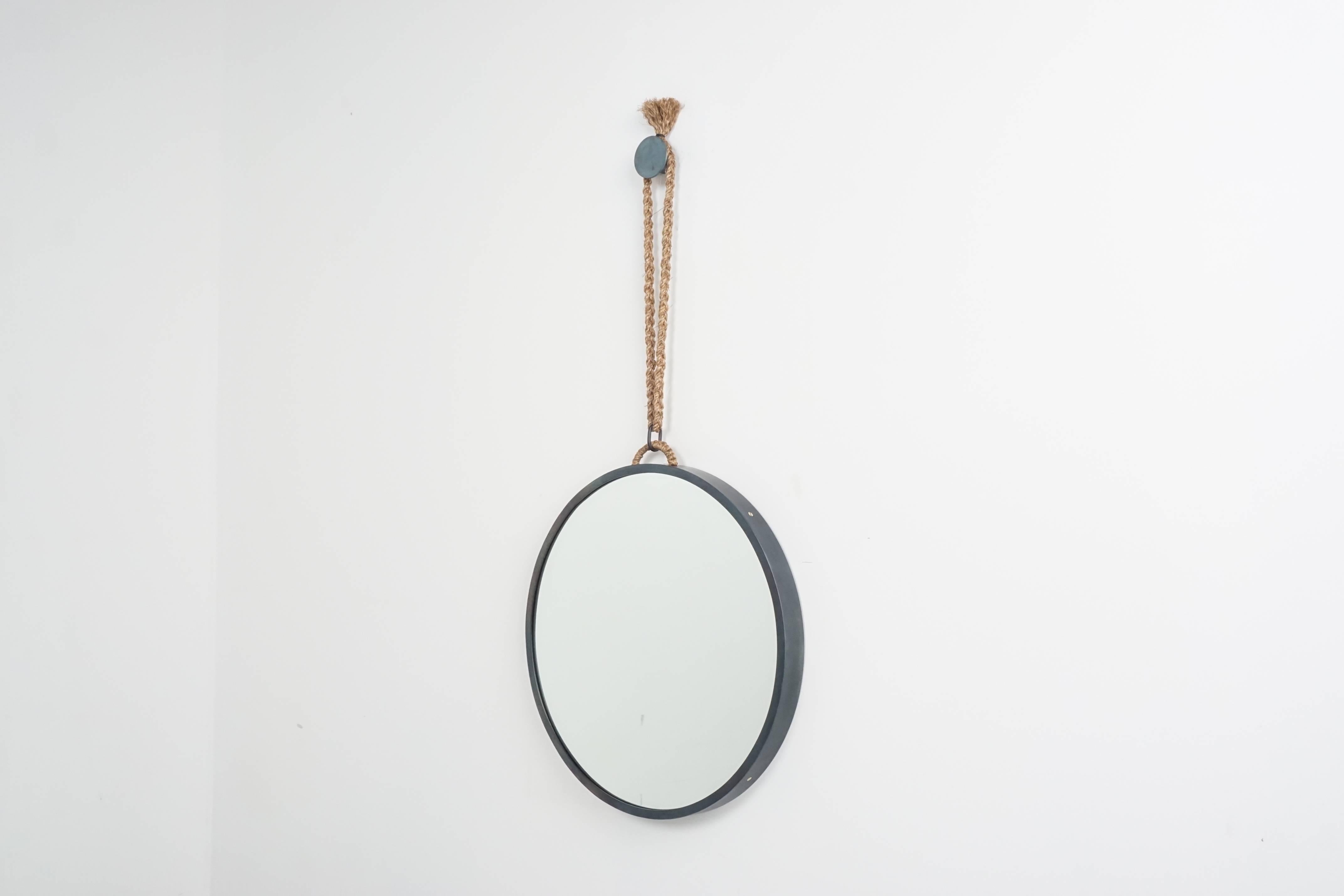 Black steel mirror designed by Orange with simple hemp detailing and matching round steel disc to hang.

24