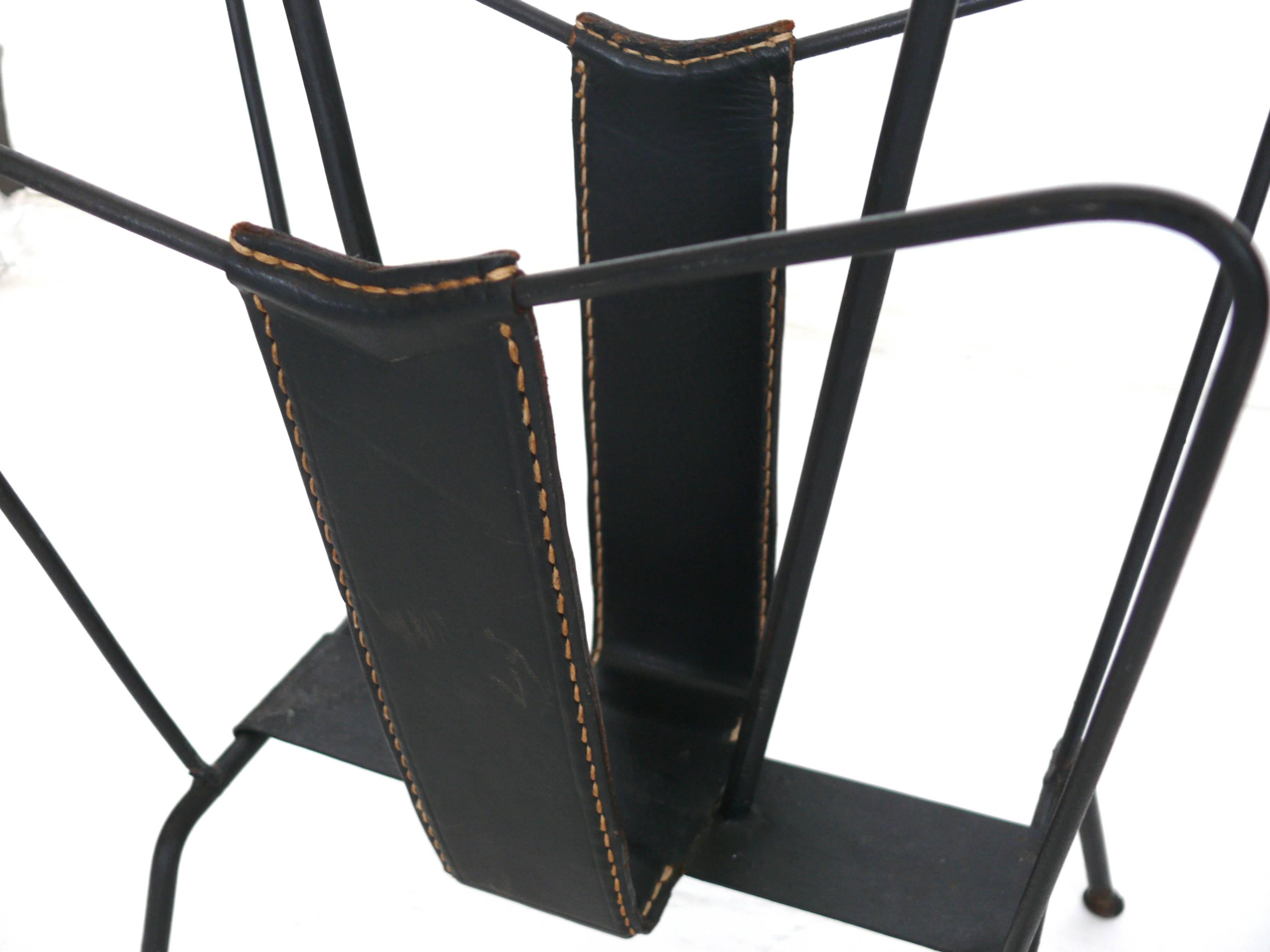 Handsome magazine rack by Jacques Adnet in black leather with contrast stitching.  Very good vintage condition.