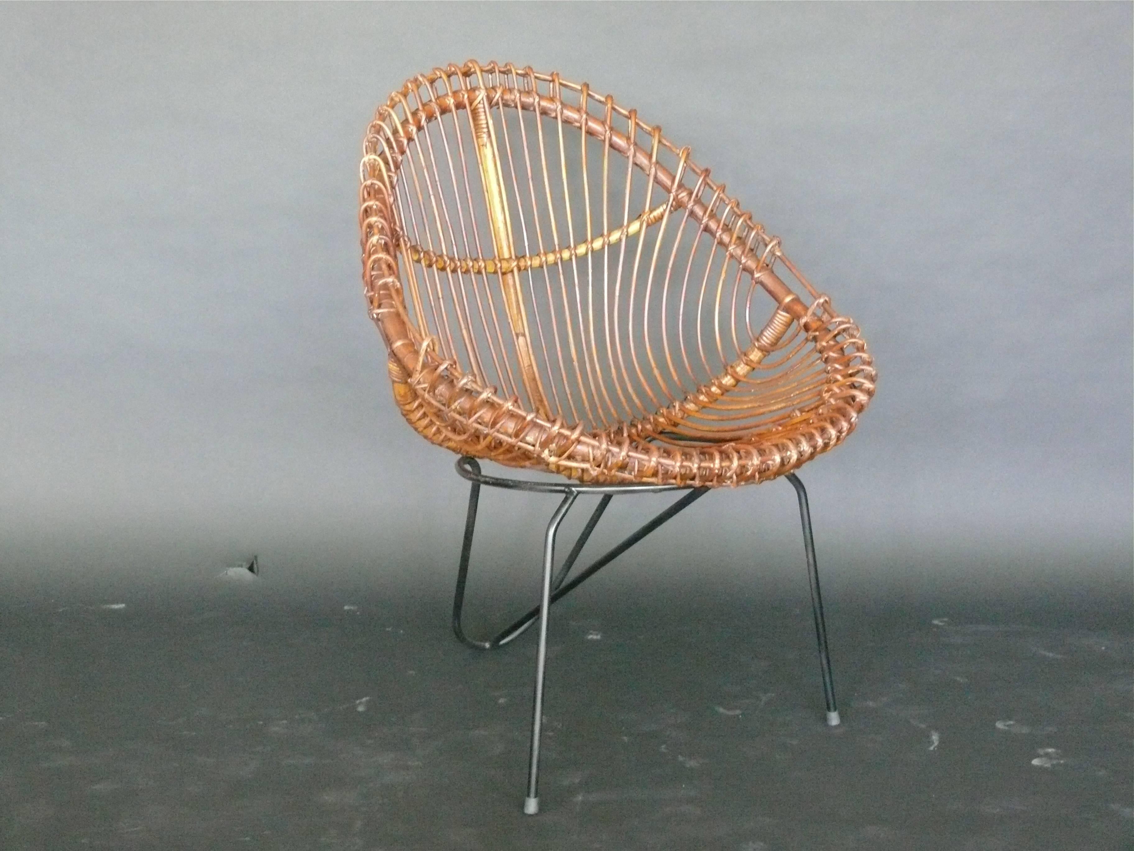 Great sculptural rattan chairs by Janine Abraham and Dirk Jan Rol. Scoop bucket seat with black iron hairpin legs. Fantastic design. Very unique. Two pairs available. Priced as a pair.