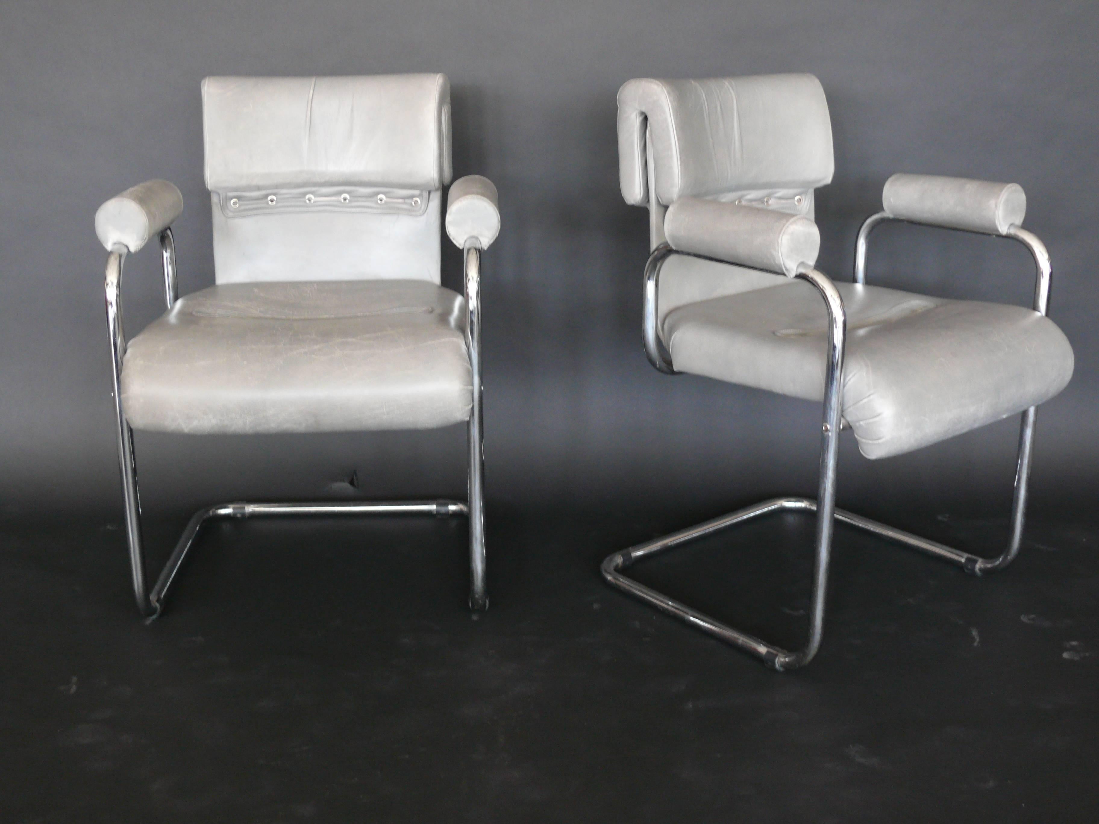 Amazing vintage grey leather chairs by Mariani for Pace Collection. Simple tubular chrome base with original soft grey leather cushions. Fantastic leather corset detailing in the back with leather straps. Sold as a set of four.