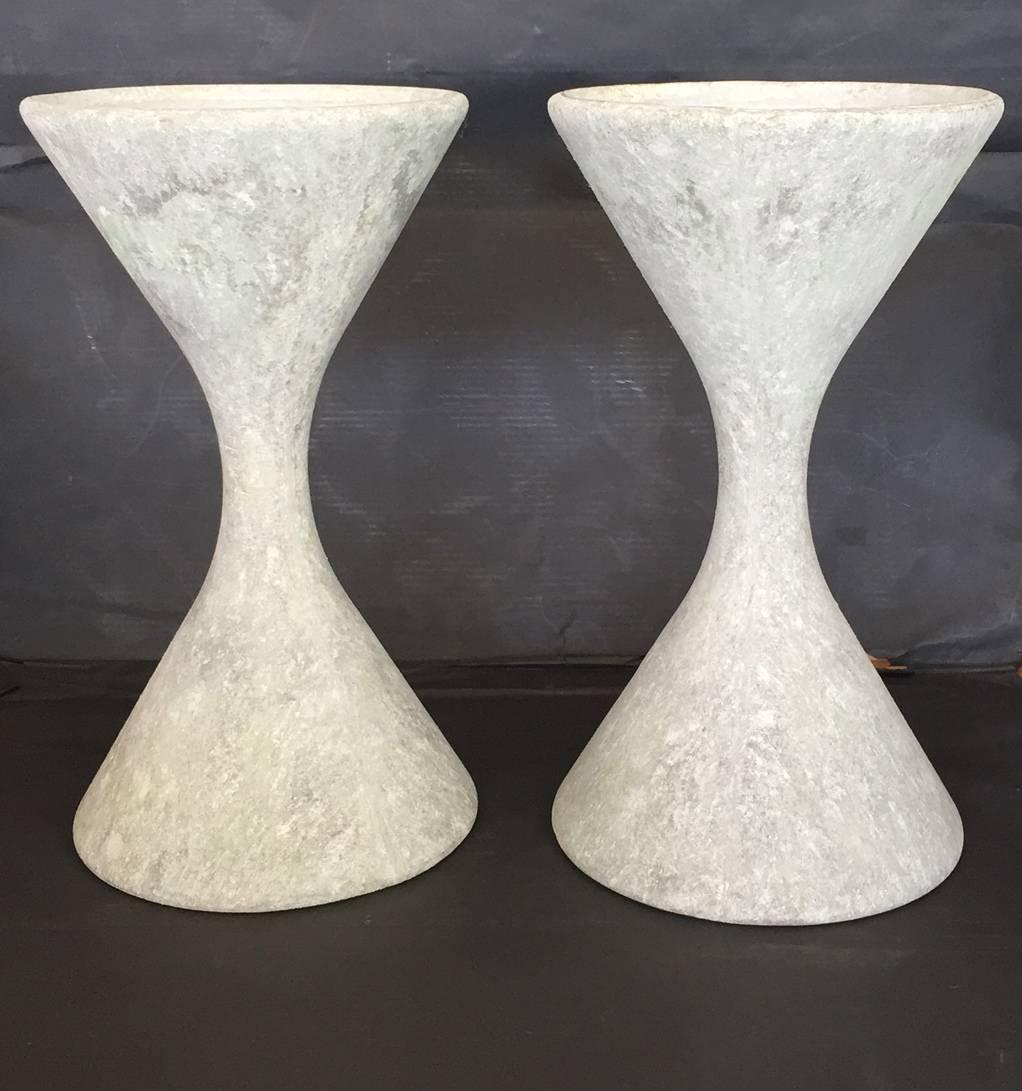 Fantastic pair of concrete hourglass planters by the Swiss Architect, Willy Guhl. Great age, patina and coloring. Iconic sculptural planter or garden object. Priced as a pair.