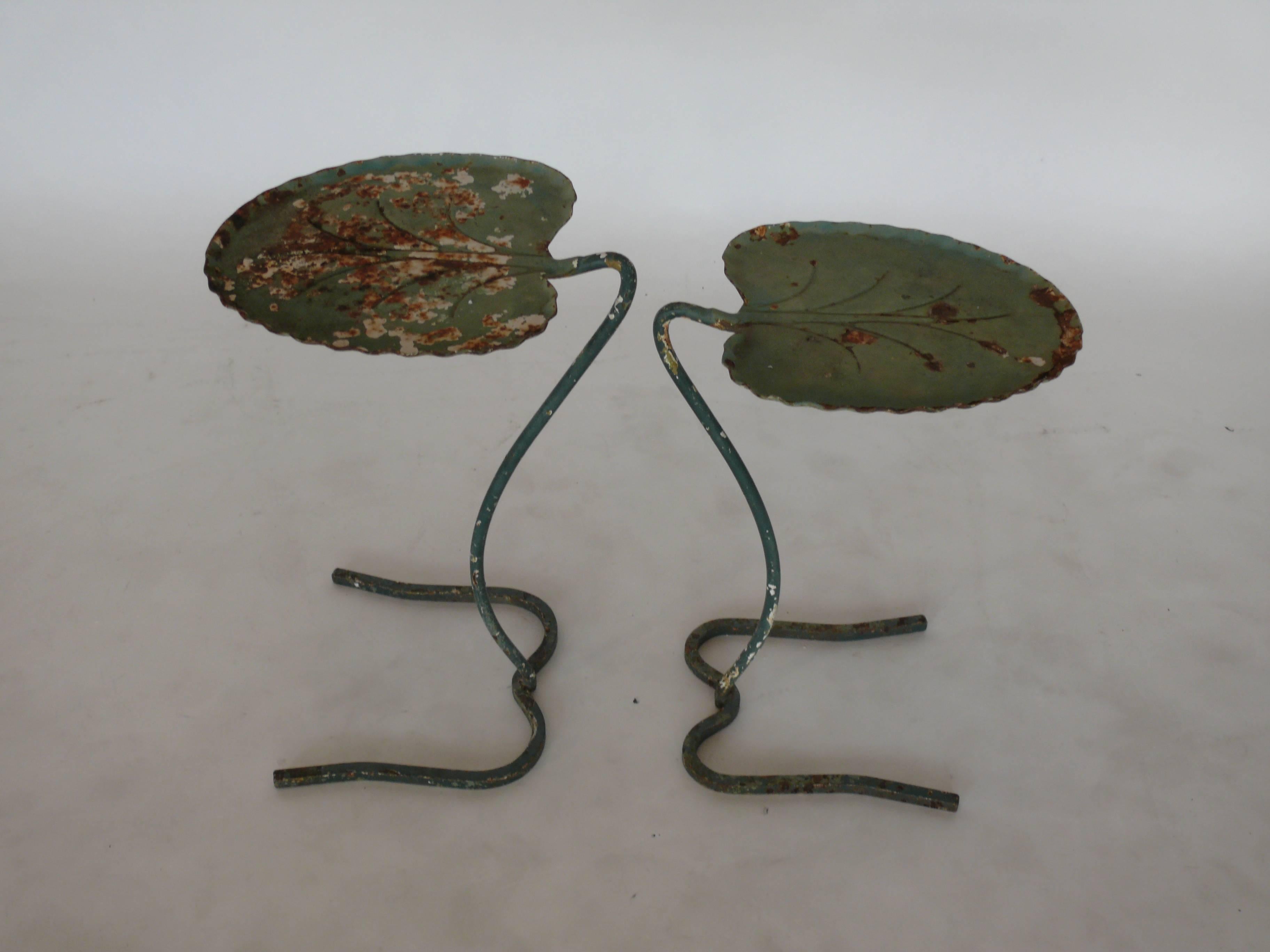 Pair of metal lily pad nesting tables designed by John Salterini. One is larger that the other and they nest together. This set has a great patina and peeling green paint revealing metal. Nice old set suitable for indoor or outdoor use.
Dimensions