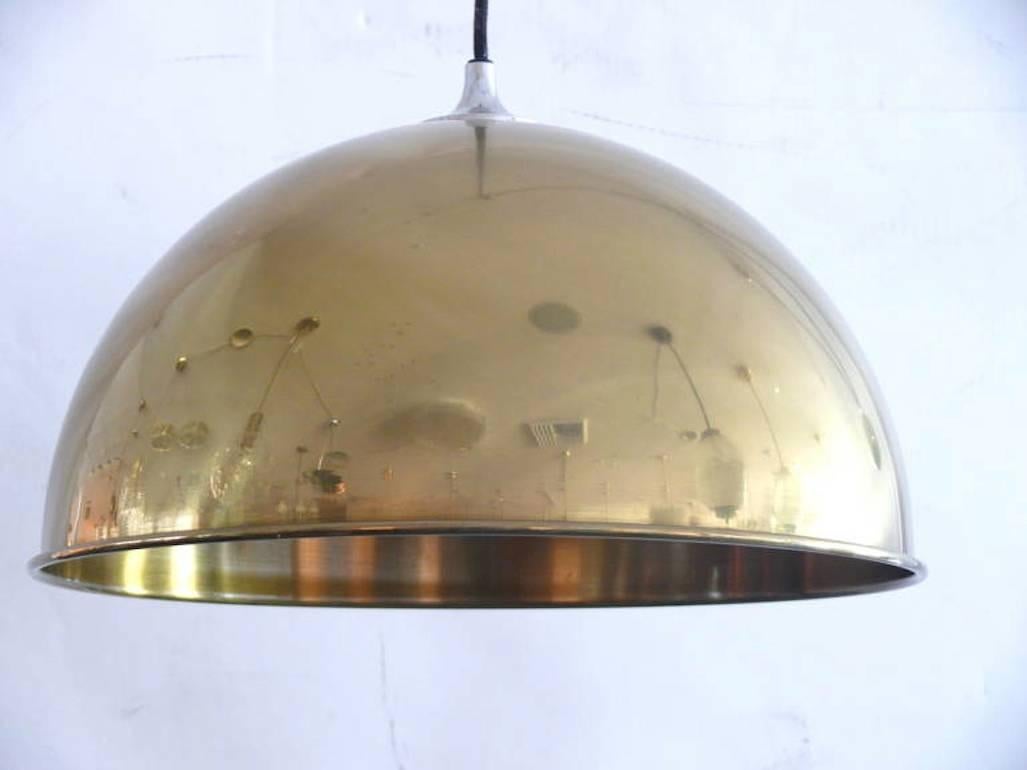 Double brass counterbalance pendant by Florian Schulz. Two brass pendants suspended, each with their own brass ball counter balance pulley system. One centre canopy supports both pendants. Each light is adjustable in height without effecting the