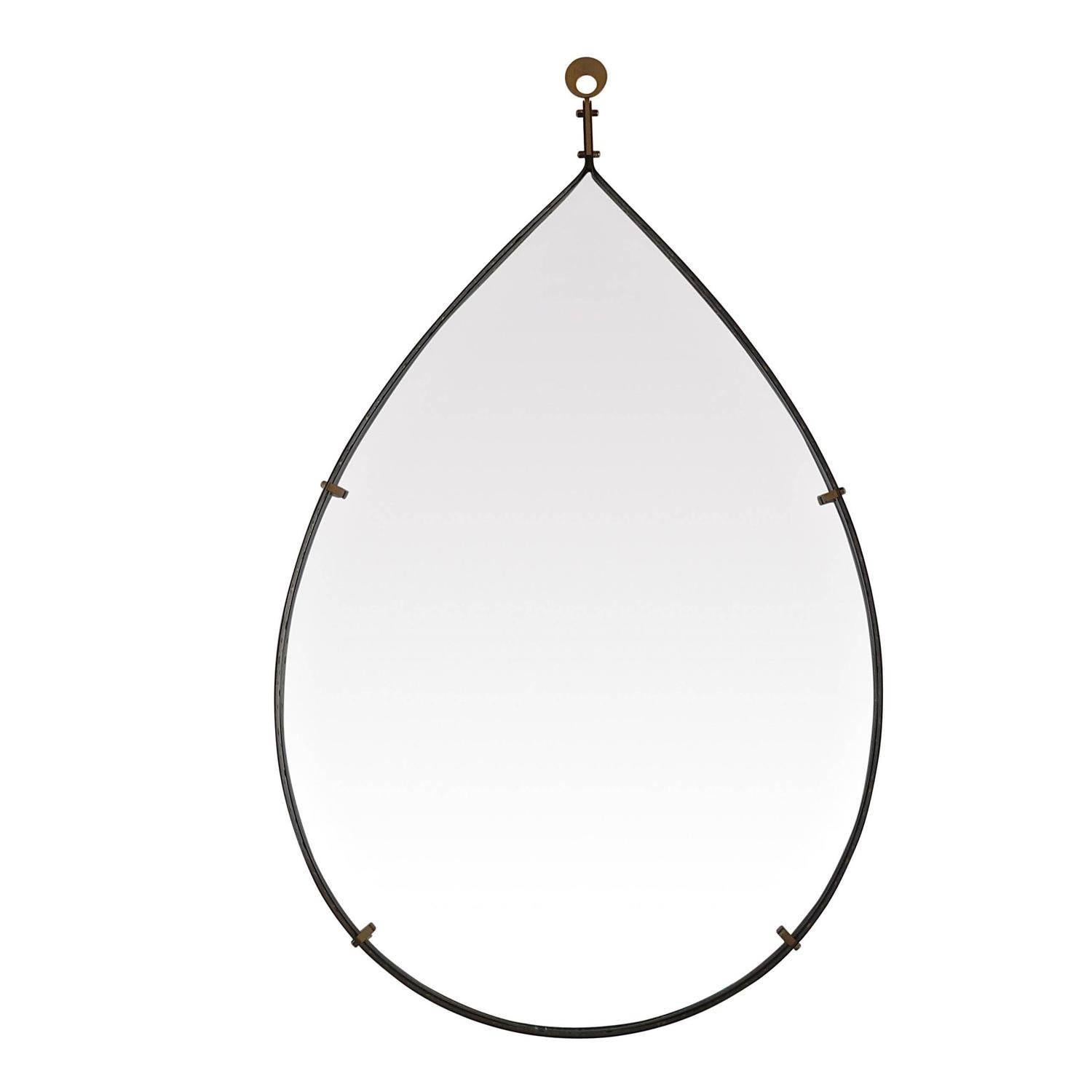 Italian brass floating mirror in tear drop shape. Unique handmade perforated detailing inside brass trim with mirror floating by brass square hardware.