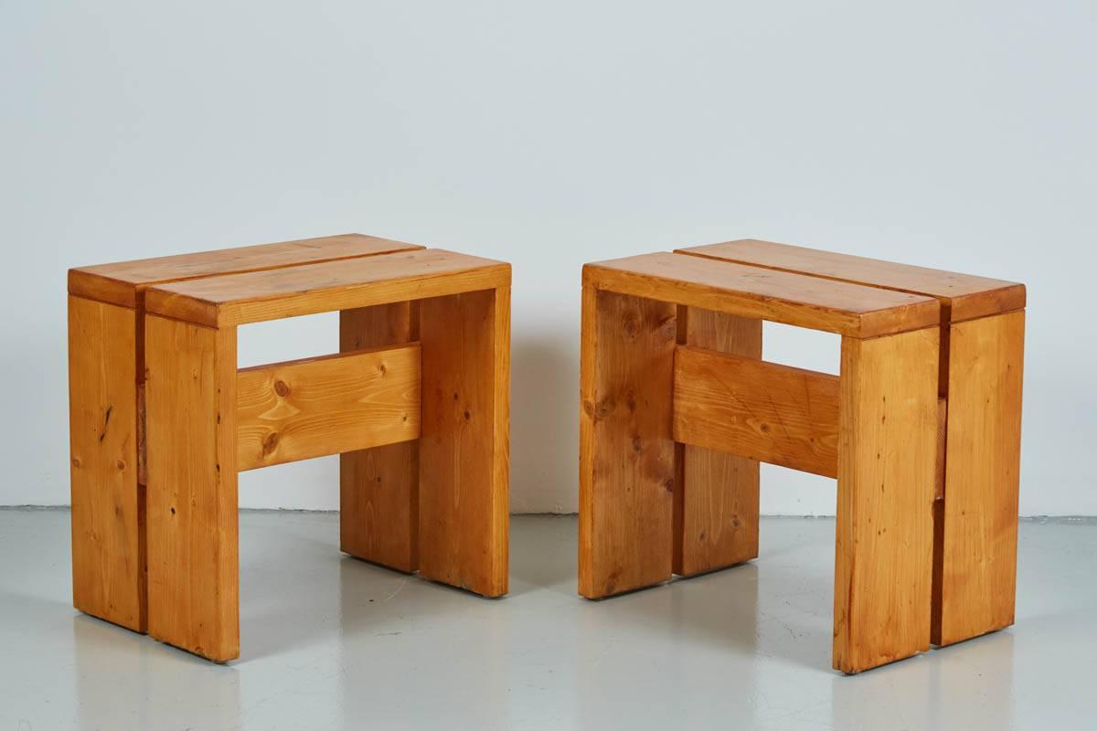 Set of four pine stools designed by Charlotte Perriand for Les Arcs Ski Lodge. Fantastic set with matching patina to all.