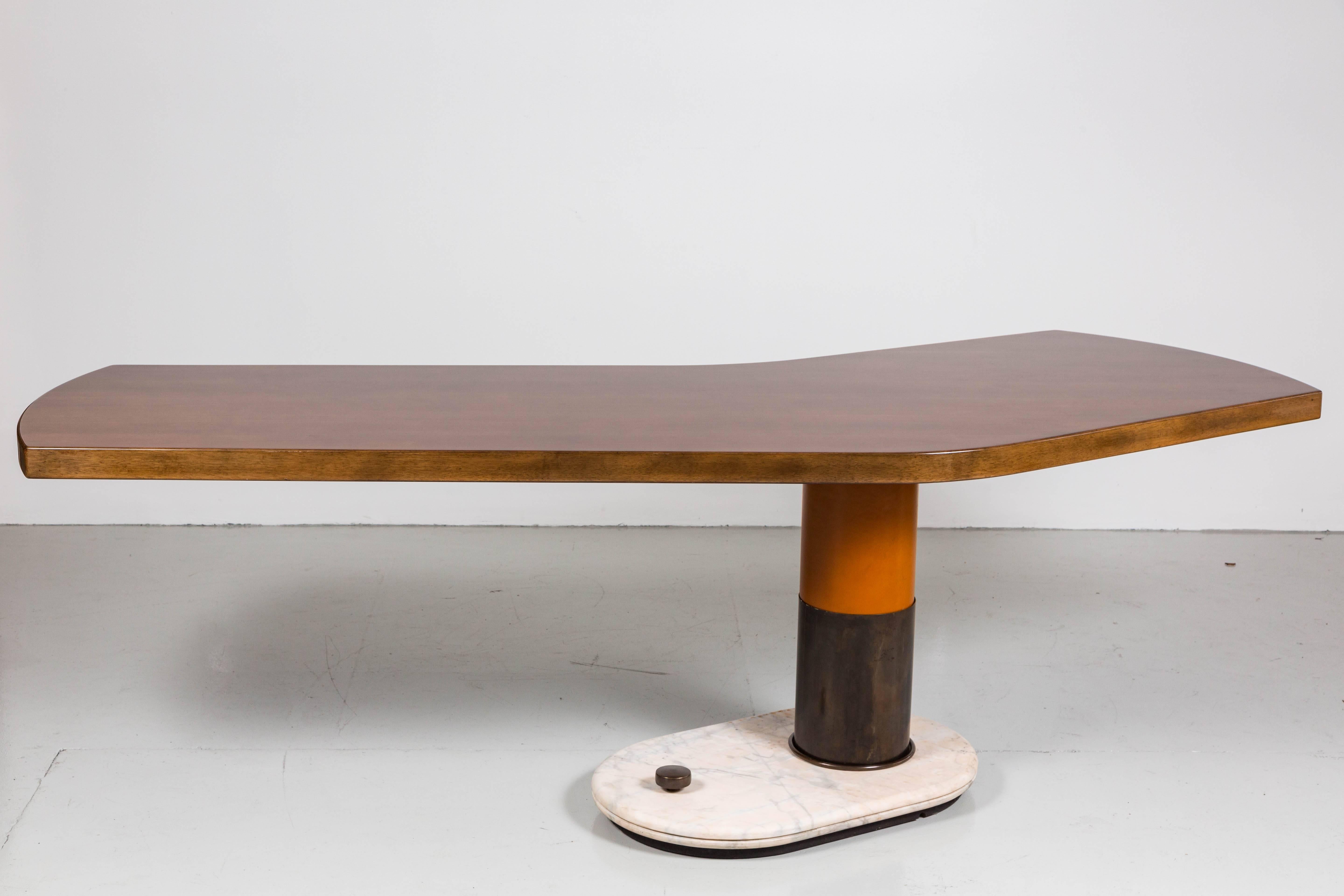 An incredible Italian desk attributed to Gio Ponti with an asymmetrical walnut top over an off center cylindrical bronze pedestal wrapped in caramel colored leather. Solid marble base has bronze trim. 
Massive in scale and truly unique piece.