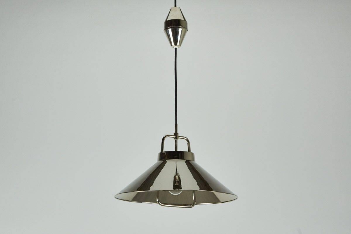 Simple polished nickel pendant that can be pulled up and down according to light that is needed. Cord retracts into the nickel diamond shape. 
Great design at it's best.