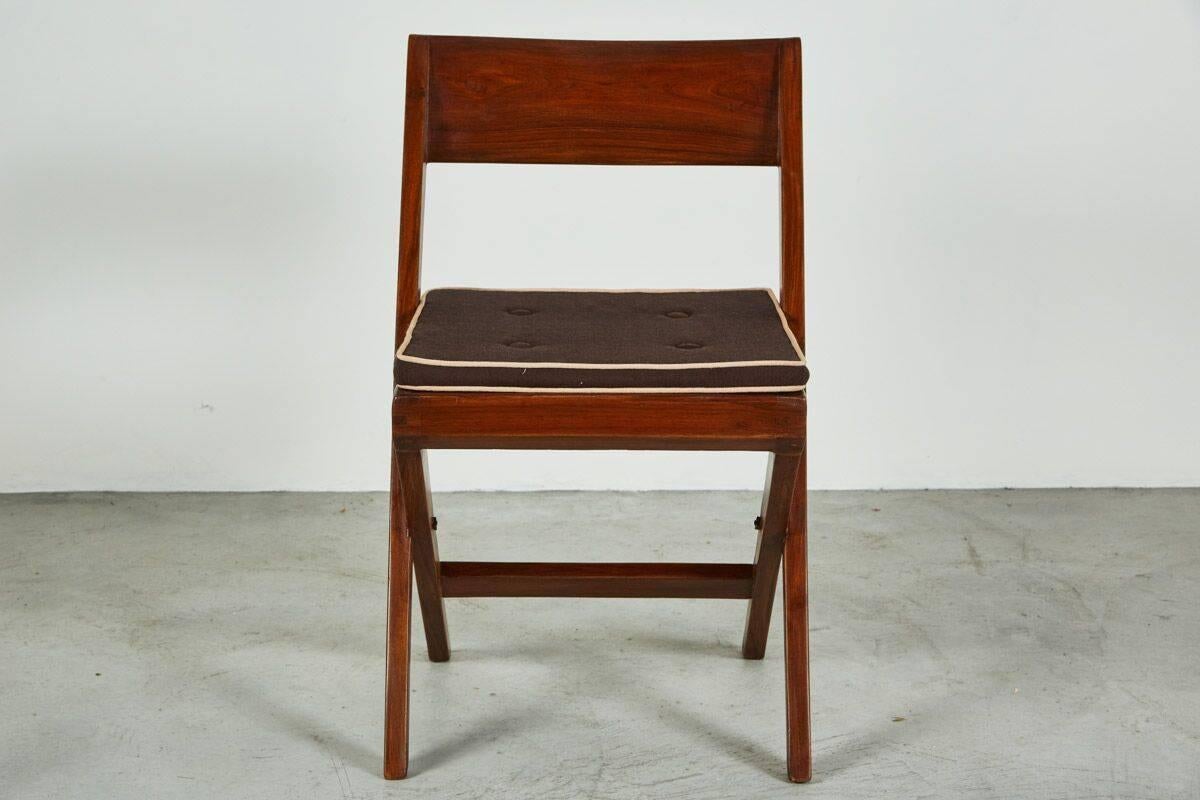 Pierre Jeanneret library chair designed for the Panjab University Library in the city of Chandigarh, India. The chair is made out of solid teak and cane with original cushion seat.
