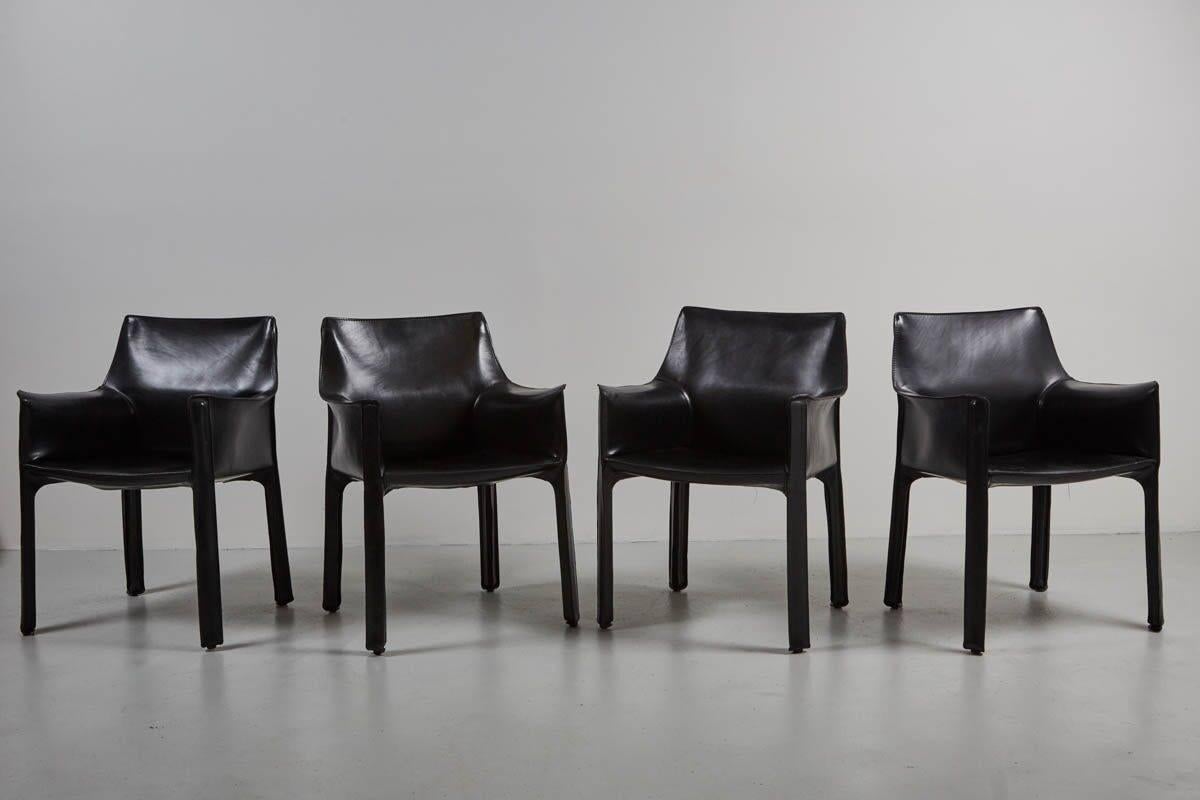 Black cab armchairs by Mario Bellini for Cassina. Leather has wonderful patina and is in excellent condition. 
6 available and priced individually.