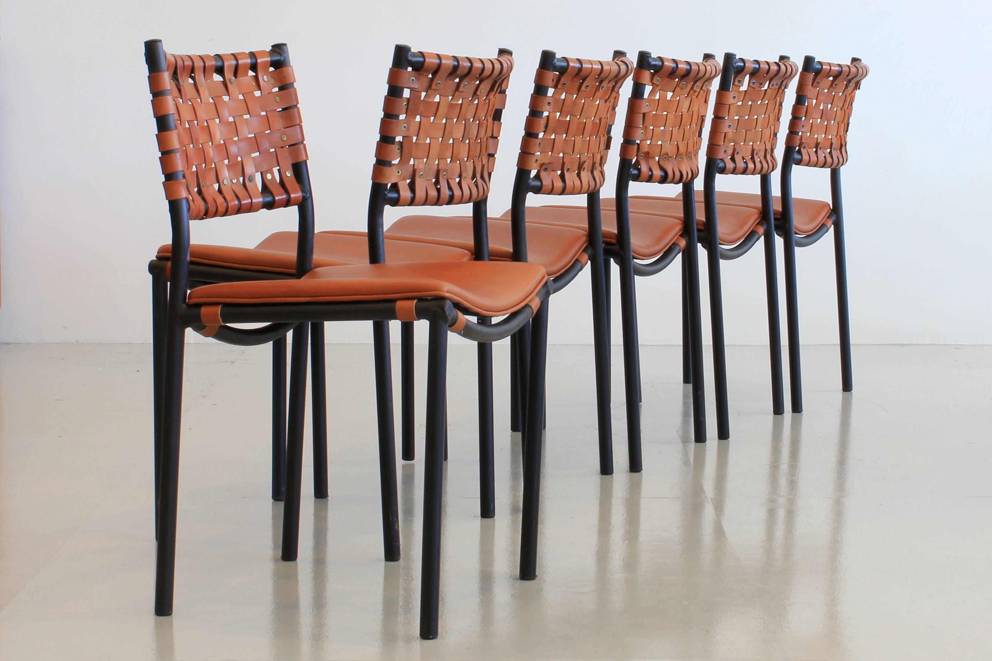 Set of six dining chairs by Shaver Howard with iron frames, original leather woven seat backs and newly upholstered leather seats.