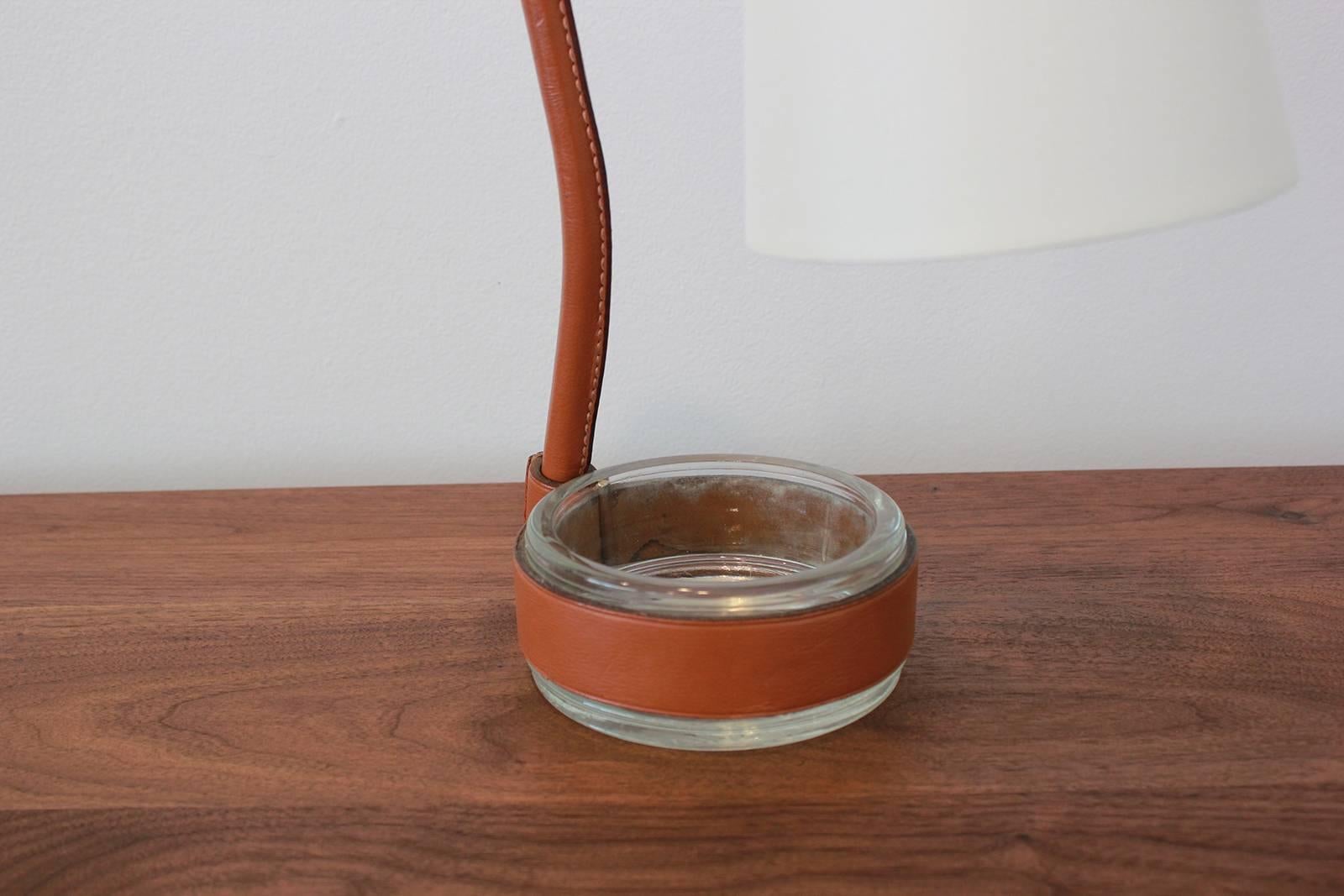 Fantastic Jacques Adnet desk lamp wrapped in Carmel leather and attached catch-all. New silk shade and newly rewired.