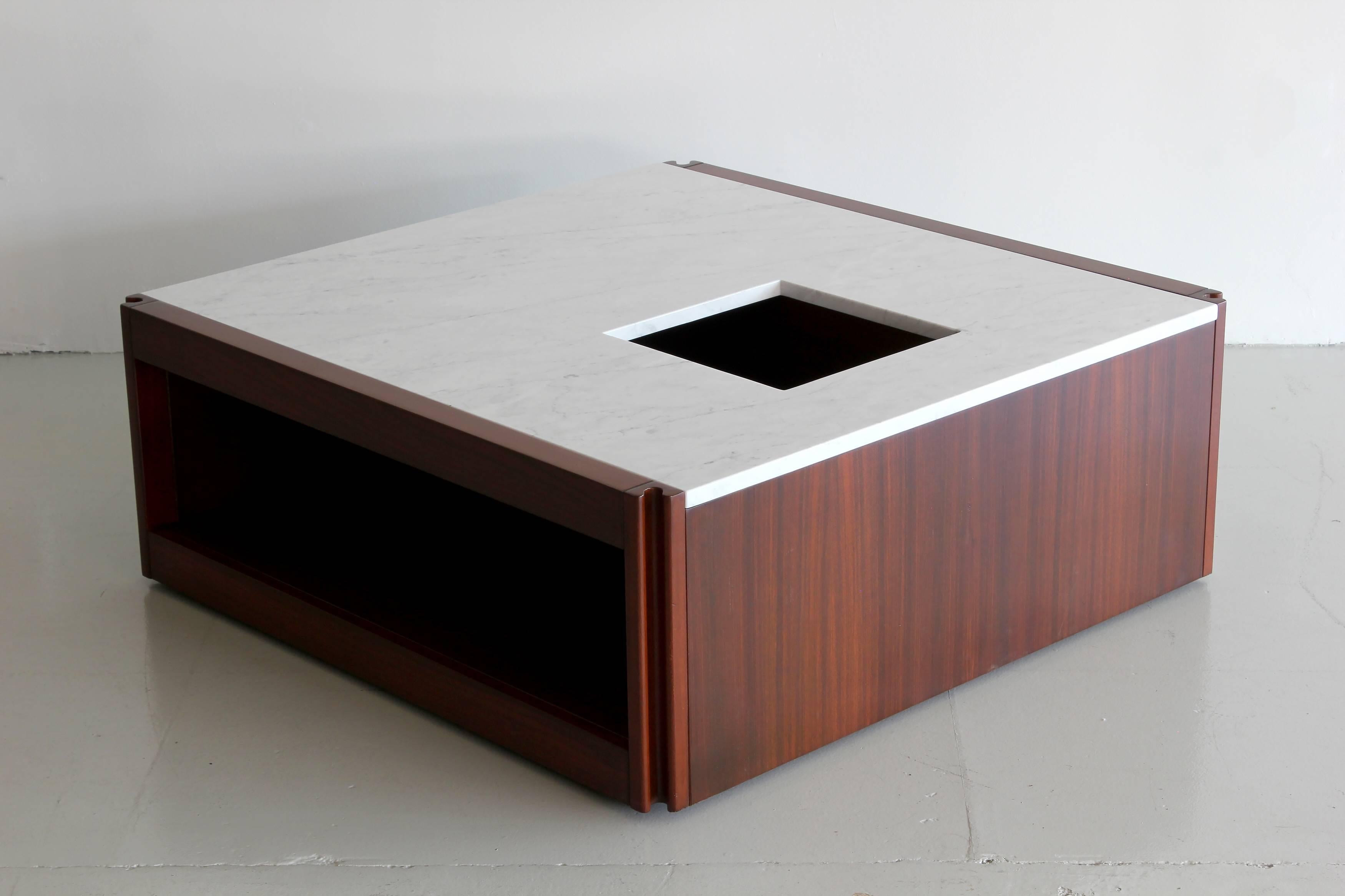 Rare marble and rosewood coffee table by Angelo Mangiarotti for Molteni. Beautiful squared shape with rosewood base and marble top with two cubby hole openings and a central plant holder. The piece has all edges designed with an ergonomic shape and