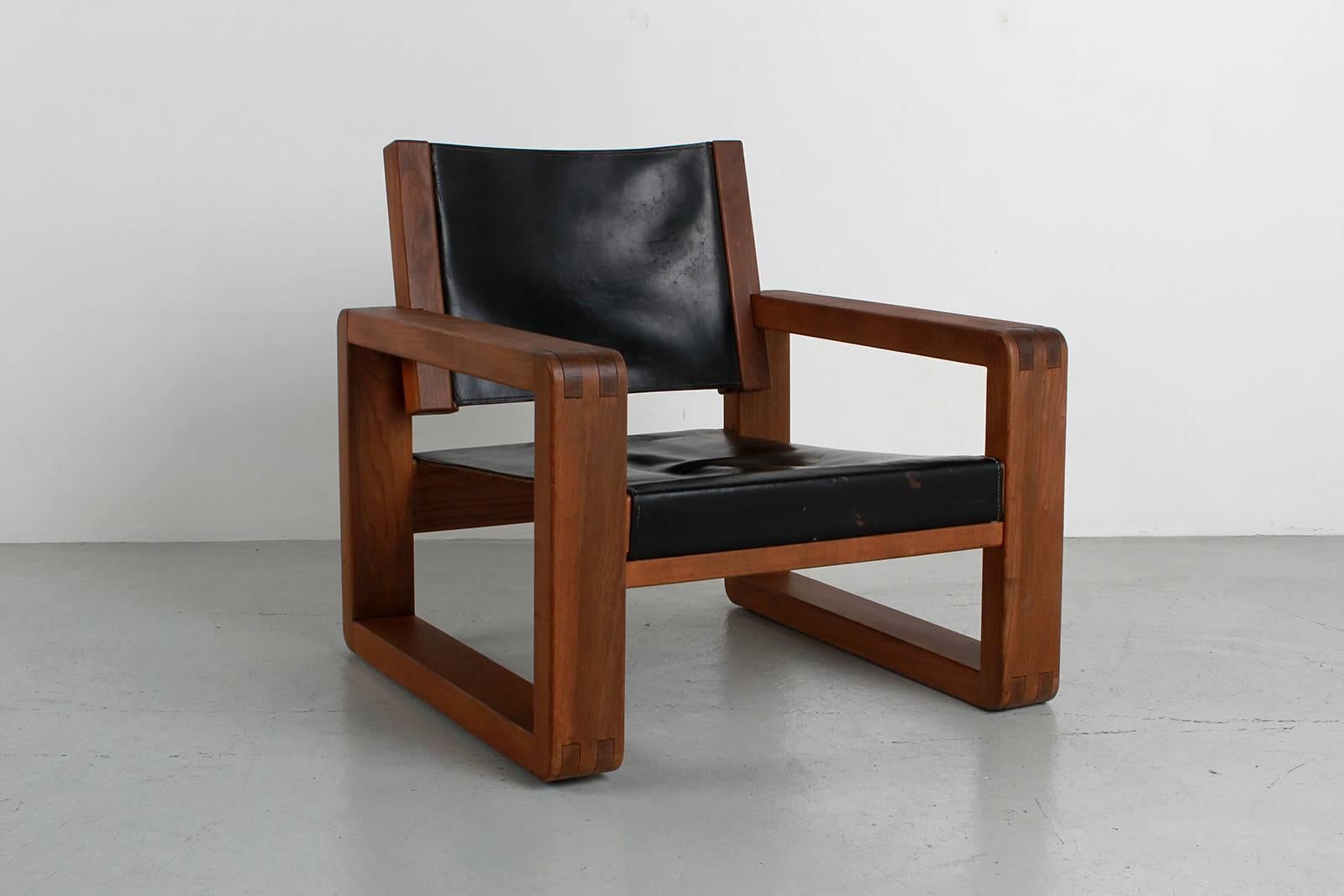 Armchair designed in the style of French designer Pierre Chapo for Atelier Chapo, Paris. Cubic design of solid elmwood with black leather seat. Beautiful wood joint detail and fantastic patina to leather with contrast stitching. Great scale.