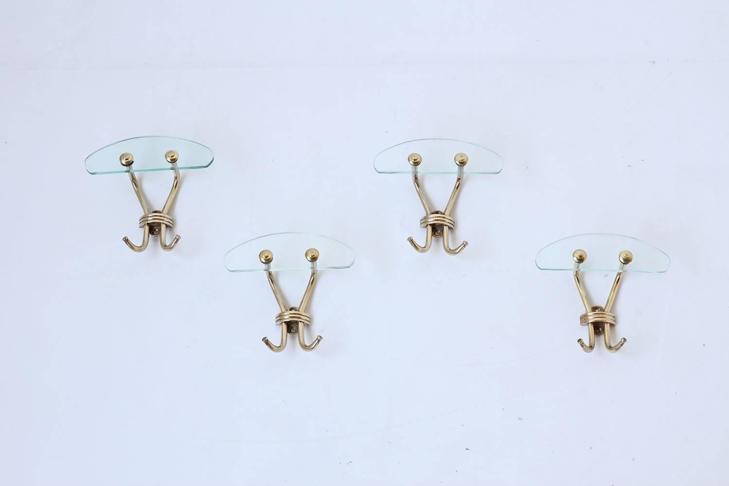 Set of four Italian glass and brass coat hooks.
Sold as a set of four.