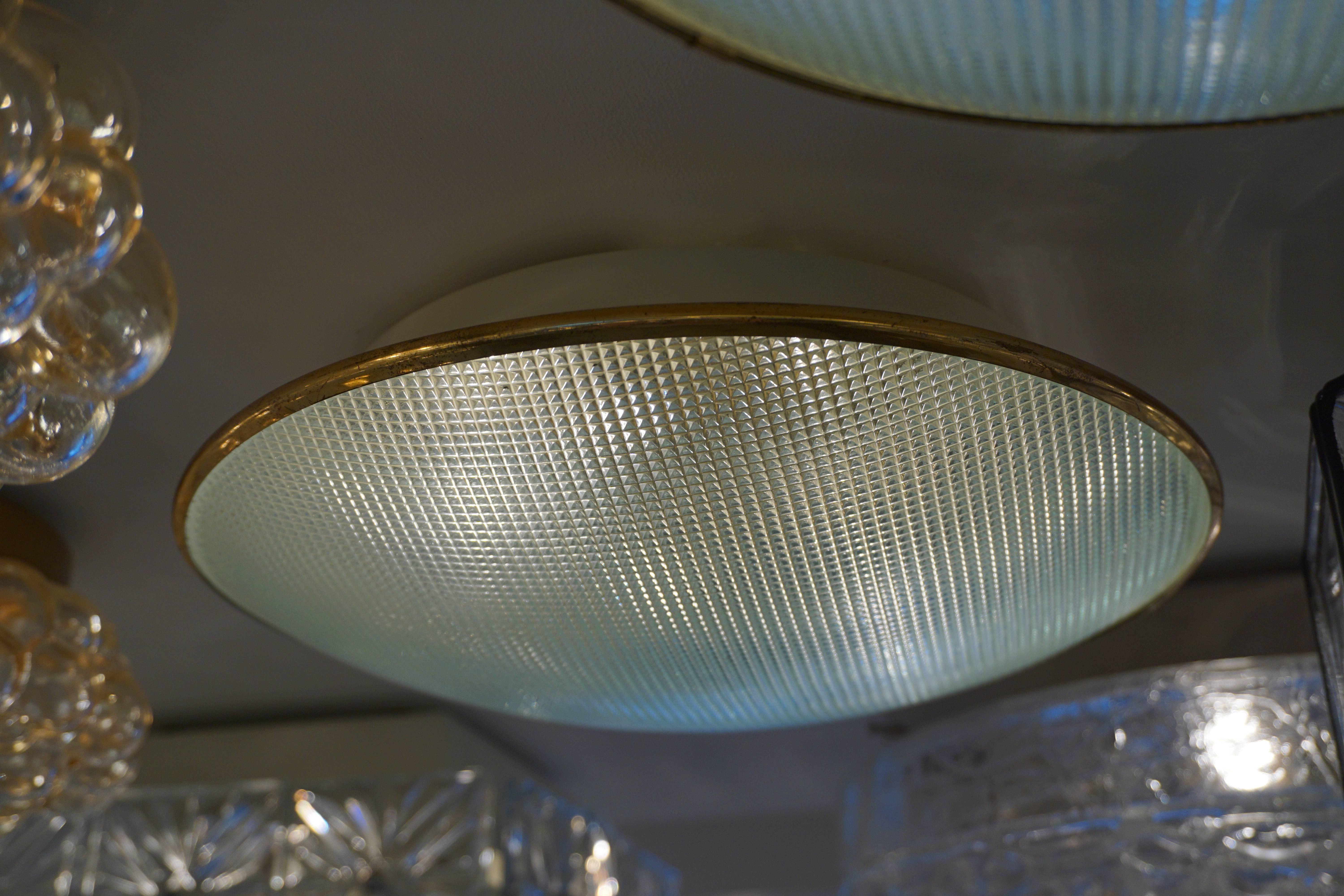 Wonderful flush mount with simple textured glass, brass trim, floating. Newly rewired.