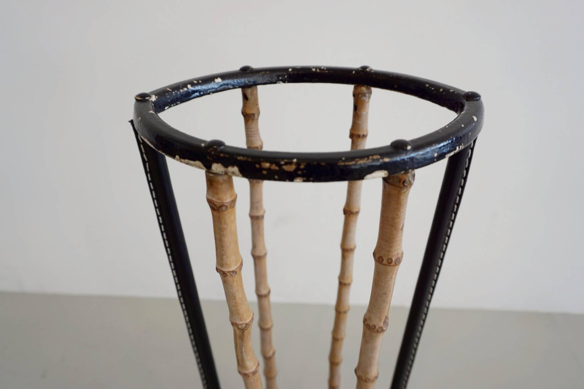 Bamboo and leather umbrella stand in the style of Jacques Adnet. Wonderful design with original bamboo and newly hand stitched leather.

Perfect for a rainy day!
 