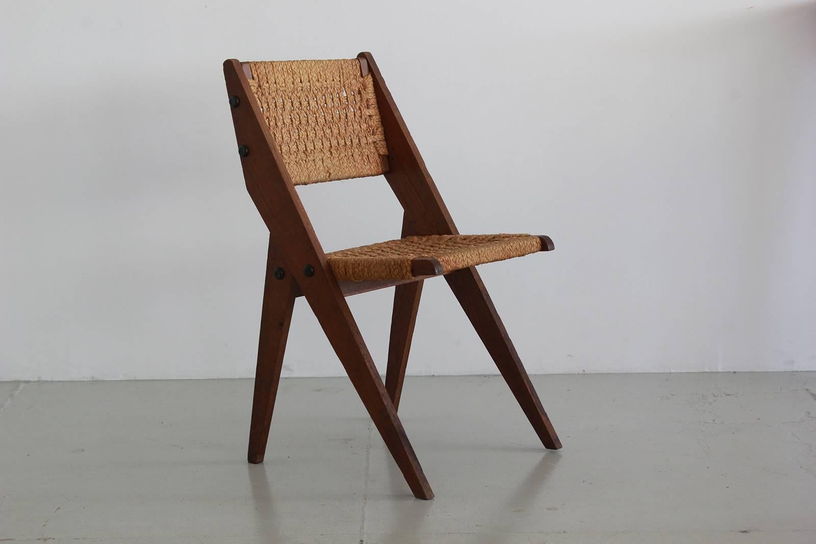Beautiful French chair by Audoux-Minet. One available.
Woven seat and back with sculptural scissor shape.