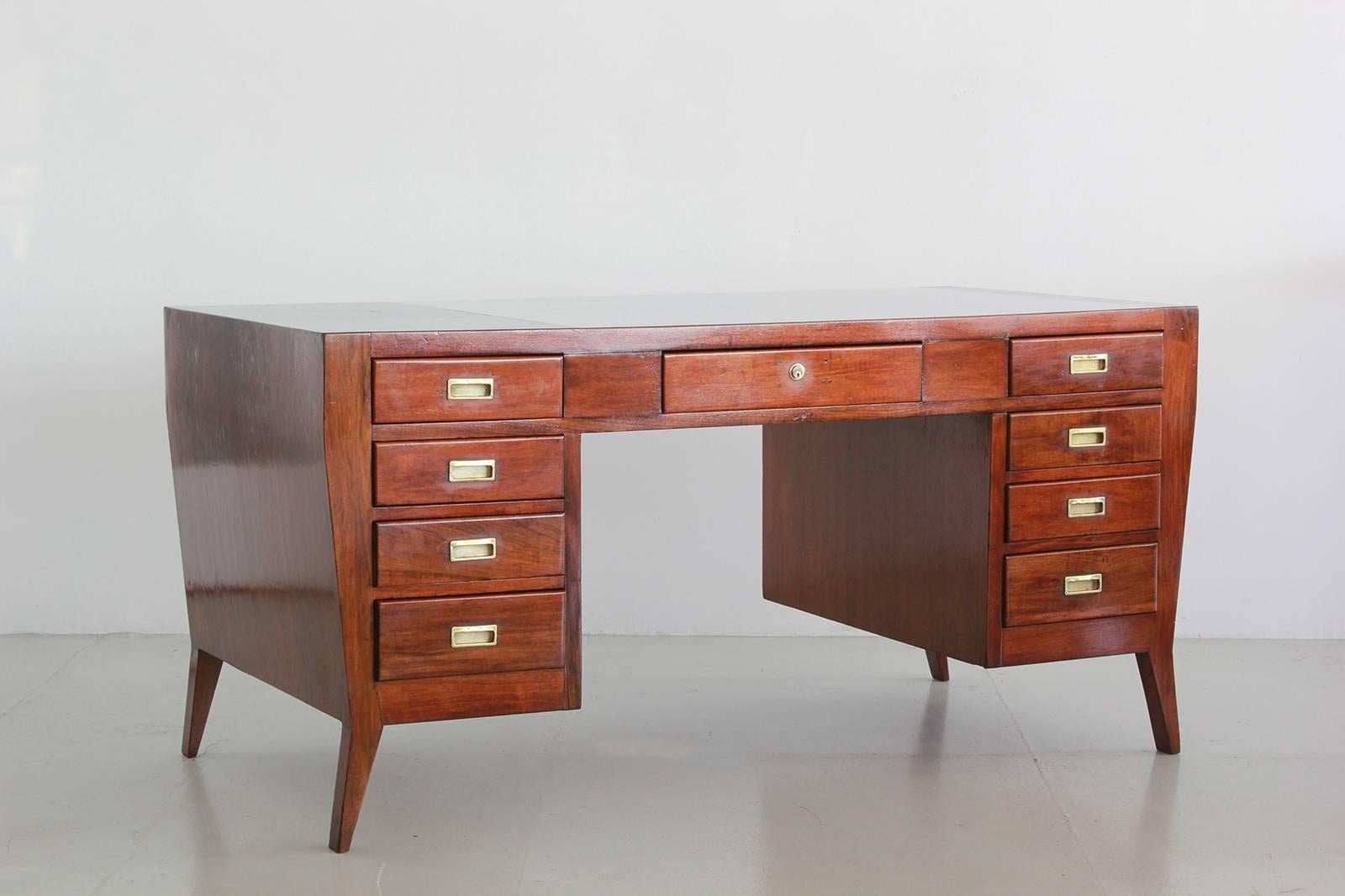 Gio Ponti designed desk for the National Labor Office.
Beautifully refinished walnut with polished brass hardware.
Top is original formica in shades of blue.