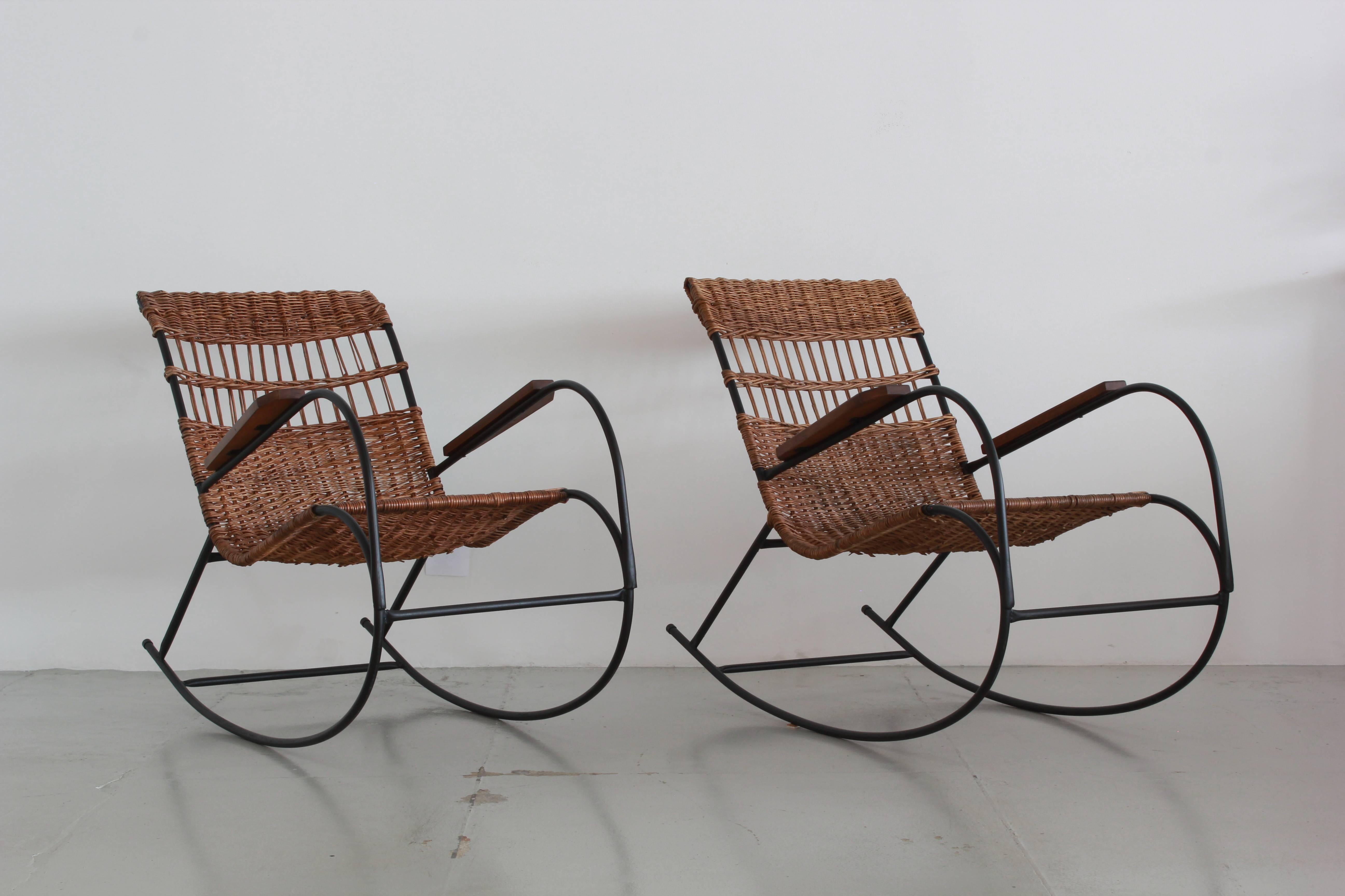 Fantastic pair of wicker rocking chairs with iron curved legs, wood arms and woven wicker seats.
Perfect for a front porch!