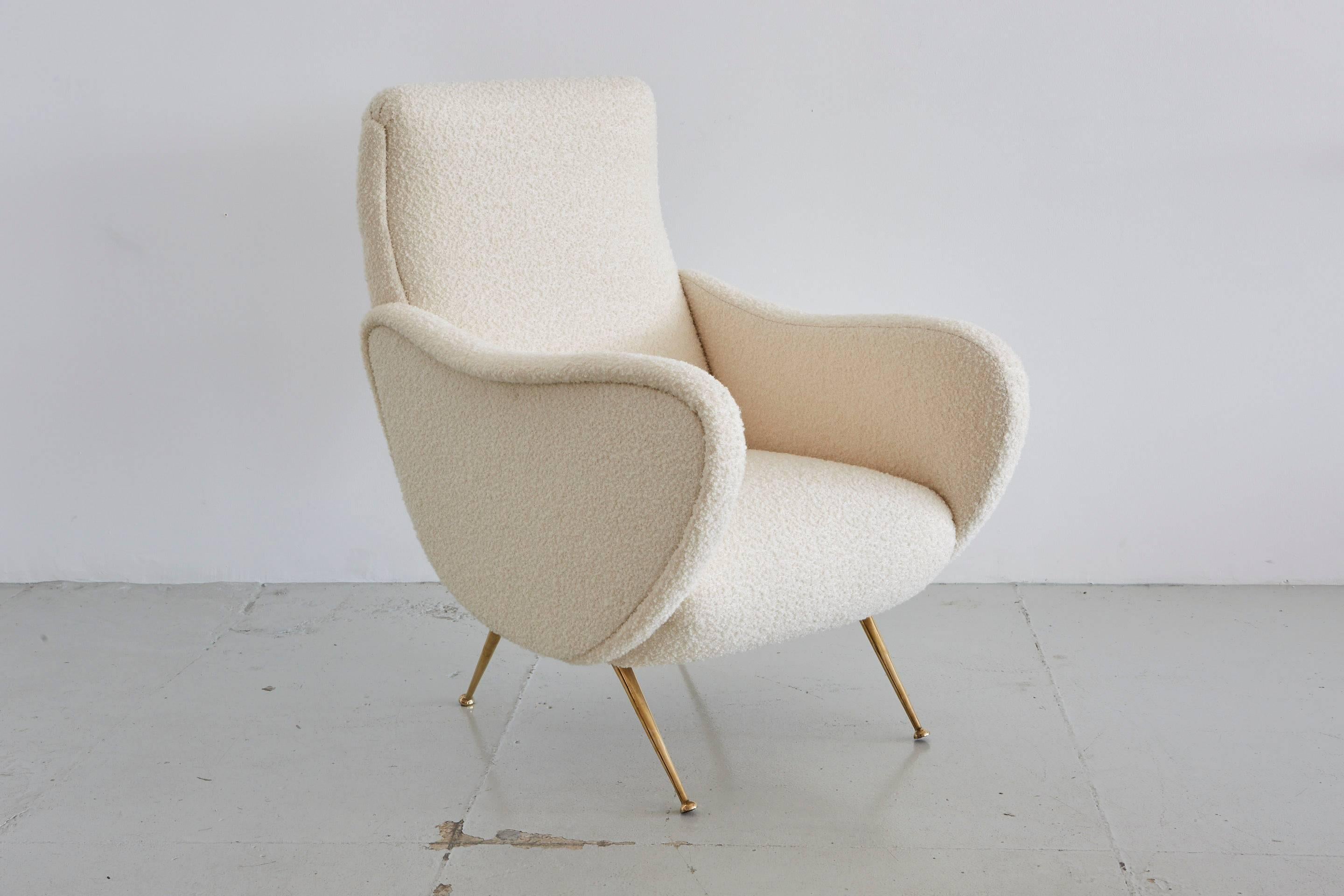 Marco Zanuso lady chair style with matching ottoman.
Reupholstered in creamy wool bouclé and newly polished brass legs.