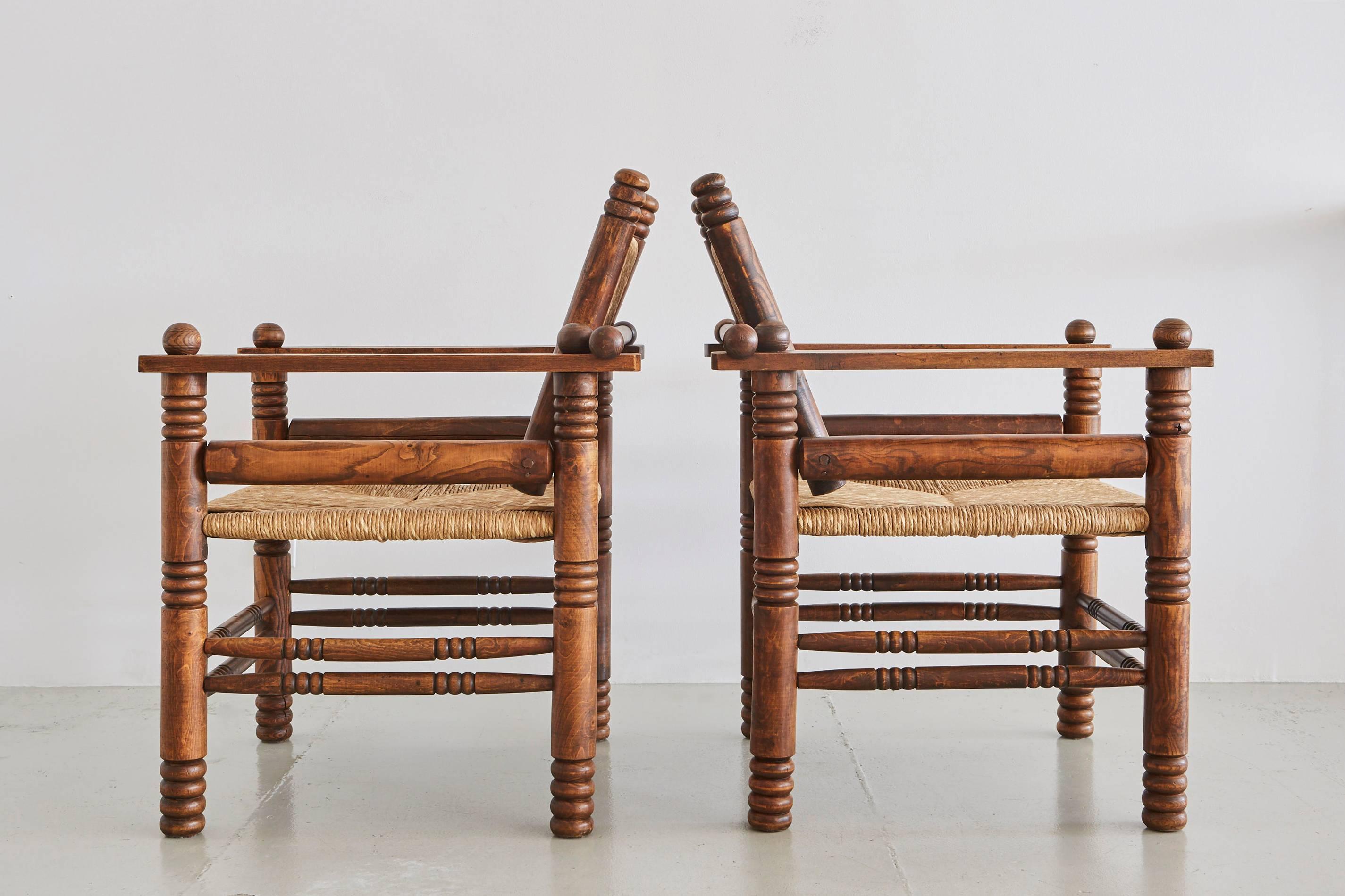 Fantastic pair of Charles Dudouyt attributed chairs with rushed seats and backs, carved oak legs and beautiful patina.
 