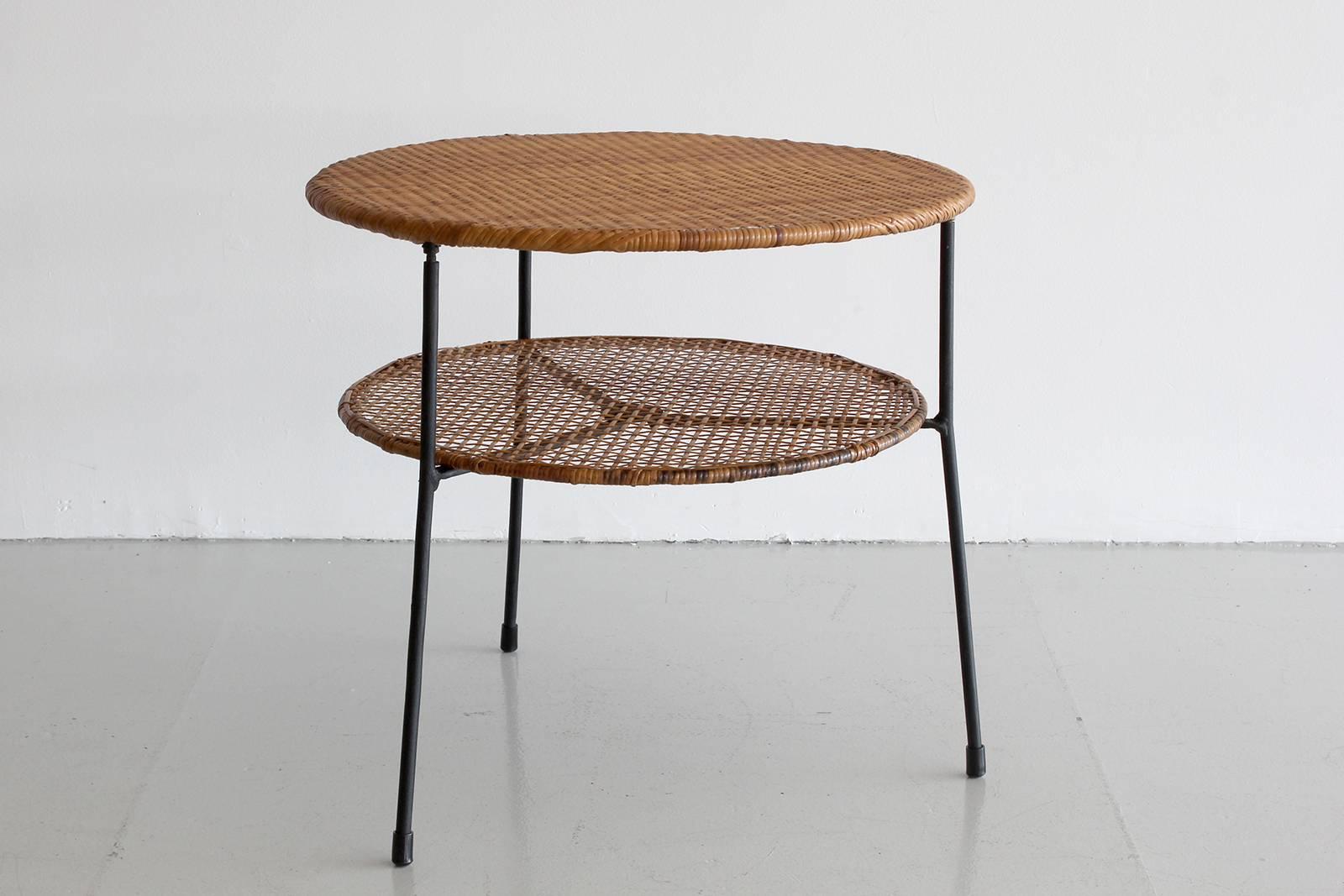 Danny Ho Fong table with iron base and floating rattan shelf.