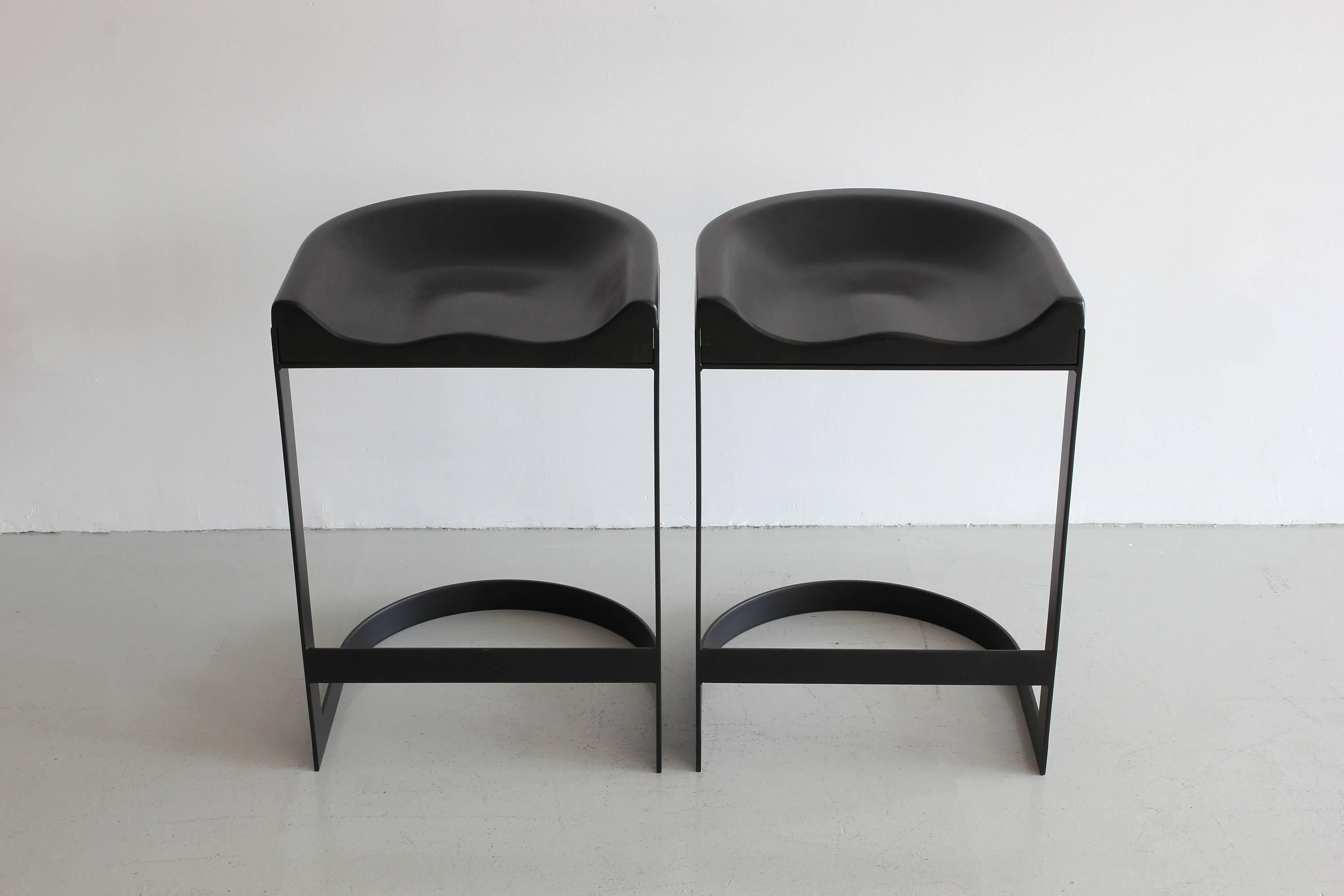 Newly produced saddle barstool in sexy black steel with black walnut contoured seat. 
Counter height
Priced individually.