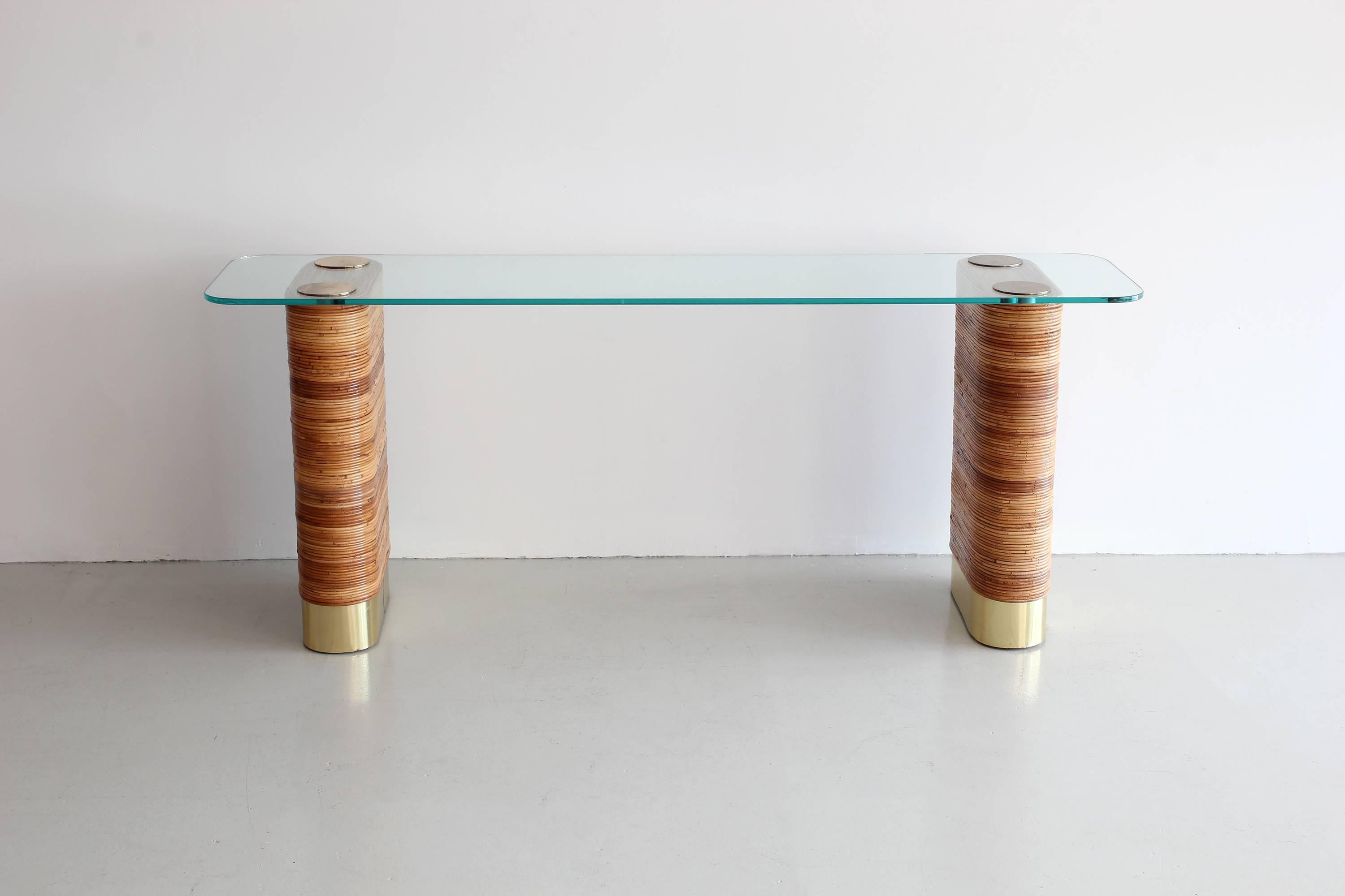 Unique double pedestal console with signature bamboo wrapped panels, thick brass capped platform and brass discs holding glass top.