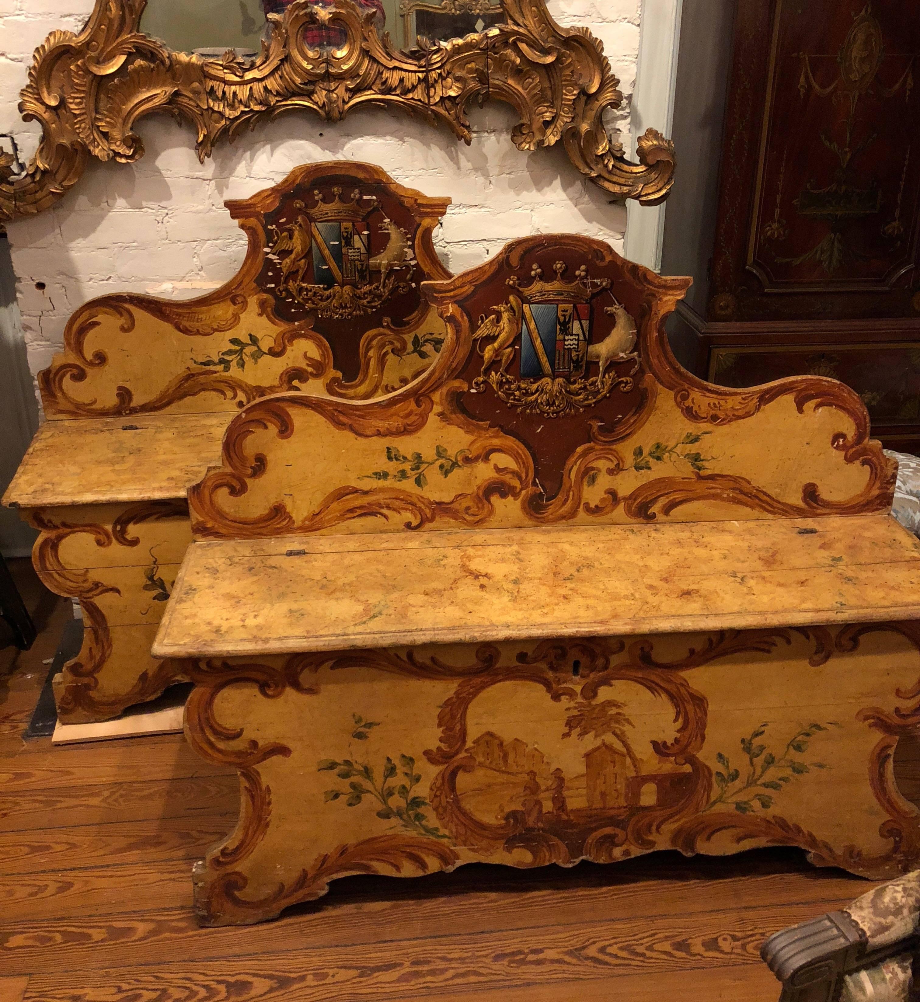 Pair of Italian painted Casapance 18th century Italian with armorial crest on each back. Pine secondary wood with hand-wrought iron lock and hinges.