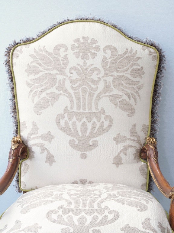 Pair of 18th century Italian Louis XV parcel gilt walnut armchairs.